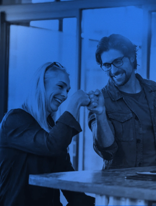 man and woman fist bumping