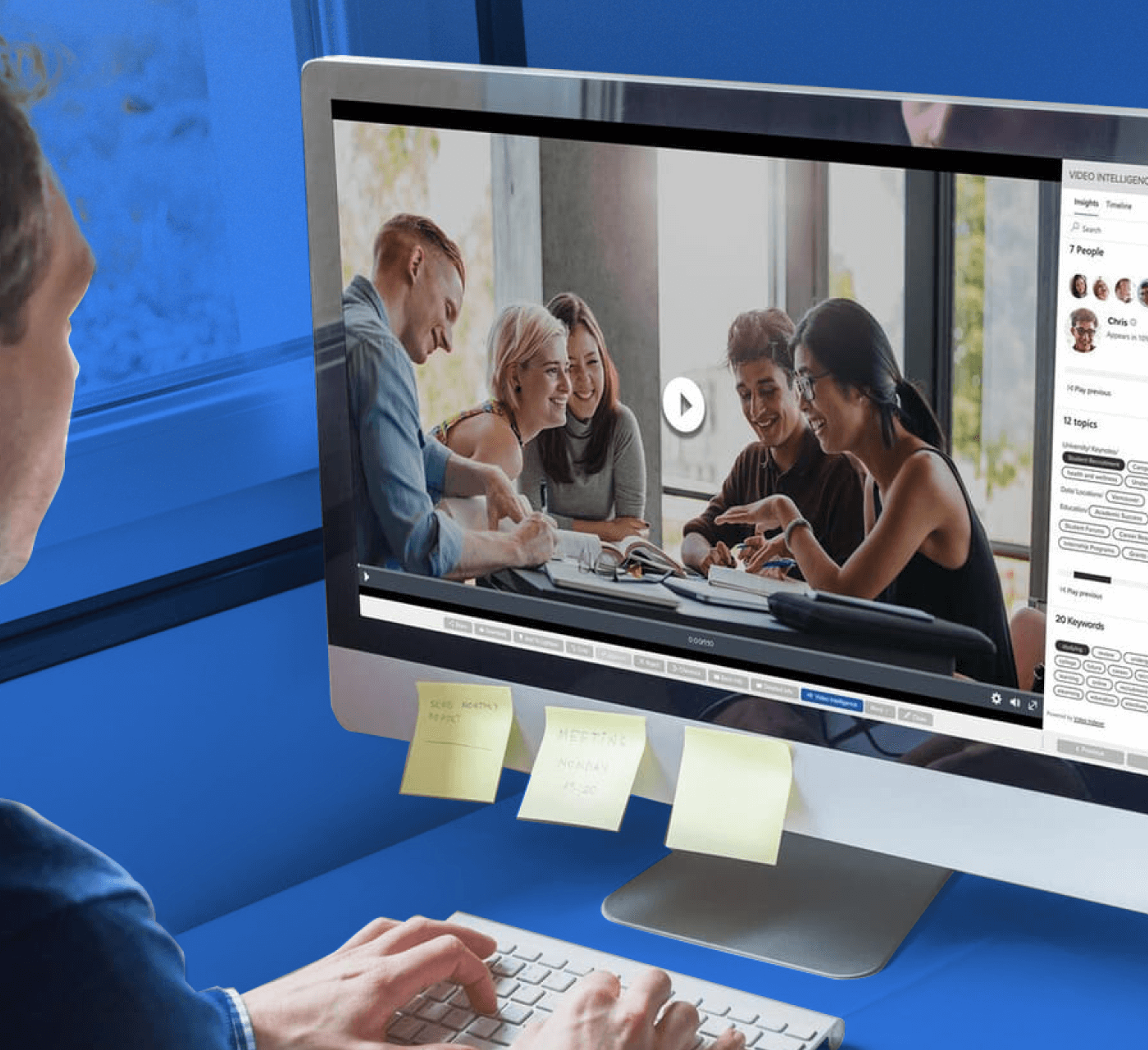 man using a digital asset management system to review a video file on a blue geometric background