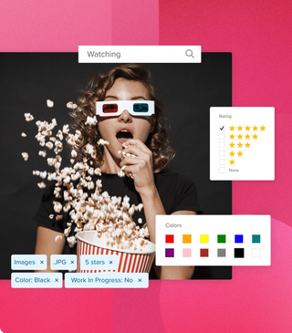 Girl wearing 3D glasses at the movie theater in shock, eating popcorn that's pouring out of the container with image tags, the search function, star rating and colour tags in the media library on a magenta geometric background