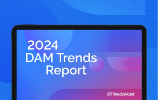 The 2024 digital asset management (DAM) trends report cover on a tablet with the mediavalet logo on bottom of a faded blue geometric shapes background