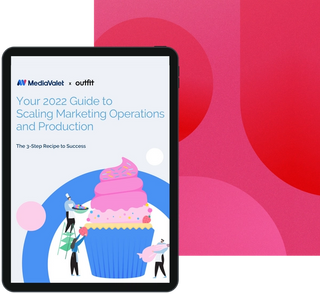 Your 2022 guide to scaling marketing operations and production eBook cover with animated pink cupcakes in a blue linger with people decorating it with the mediavalet and outfit logos in the top left corner on a geometrics faded magenta background
