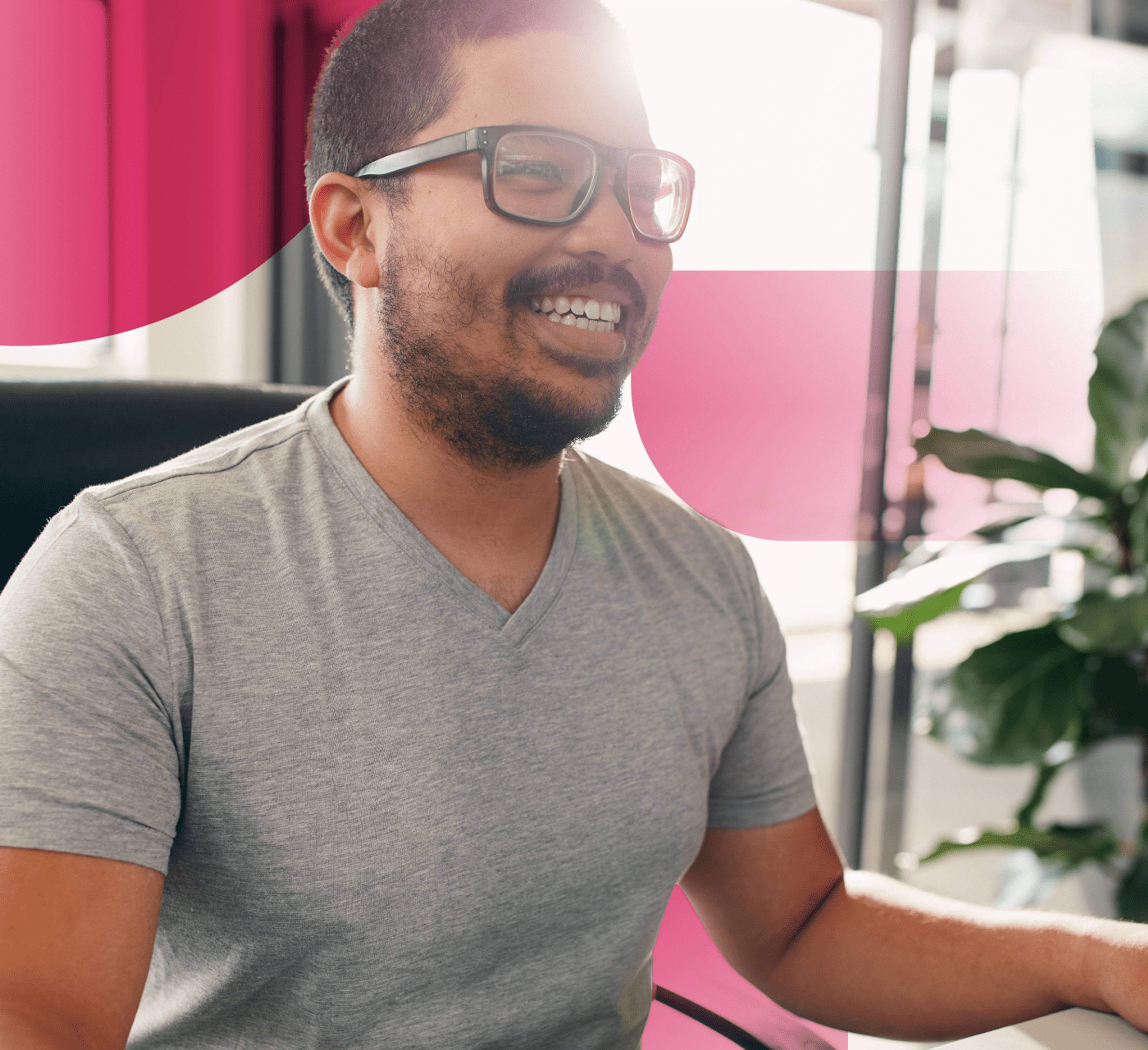 man smiling at computer screen