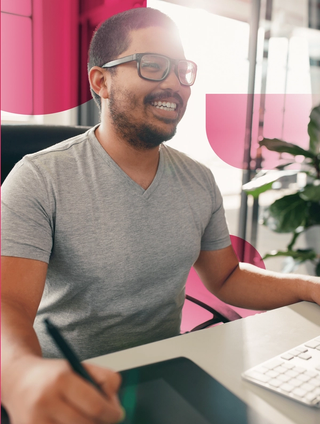 man smiling at computer screen