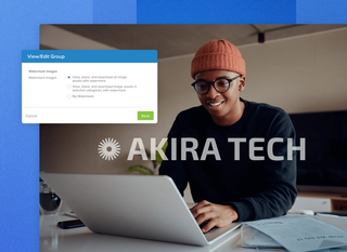 An image of a man wearing a hat and glasses working on a laptop in an apartment with paper around her with a watermark popup to view, share and download image on a blue geometric background