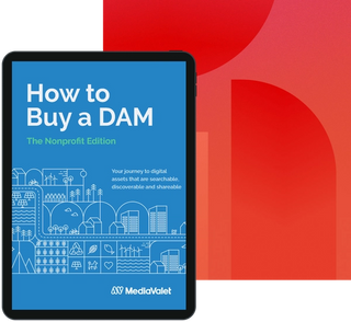 The how to buy a digital asset management (DAM) nonprofit edition guide cover on a tablet with the Mediavalet logo on top of a faded red geometric shapes background