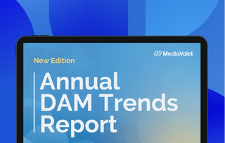The annual digital asset management (DAM) trends new edition report cover on a tablet with the mediavalet logo on top of a faded blue geometric shapes background