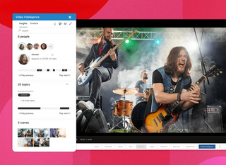 A video in the mediavalet library of three guys in a rock band performing on a stage with lights and smoke with a popup box showing video intelligence feature detecting people, topics, and scenes on a magenta geometric background