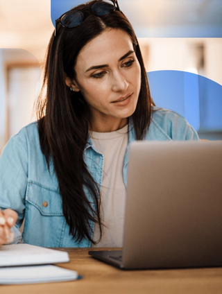 A woman on her laptop reviewing why DAM is important in 2024.