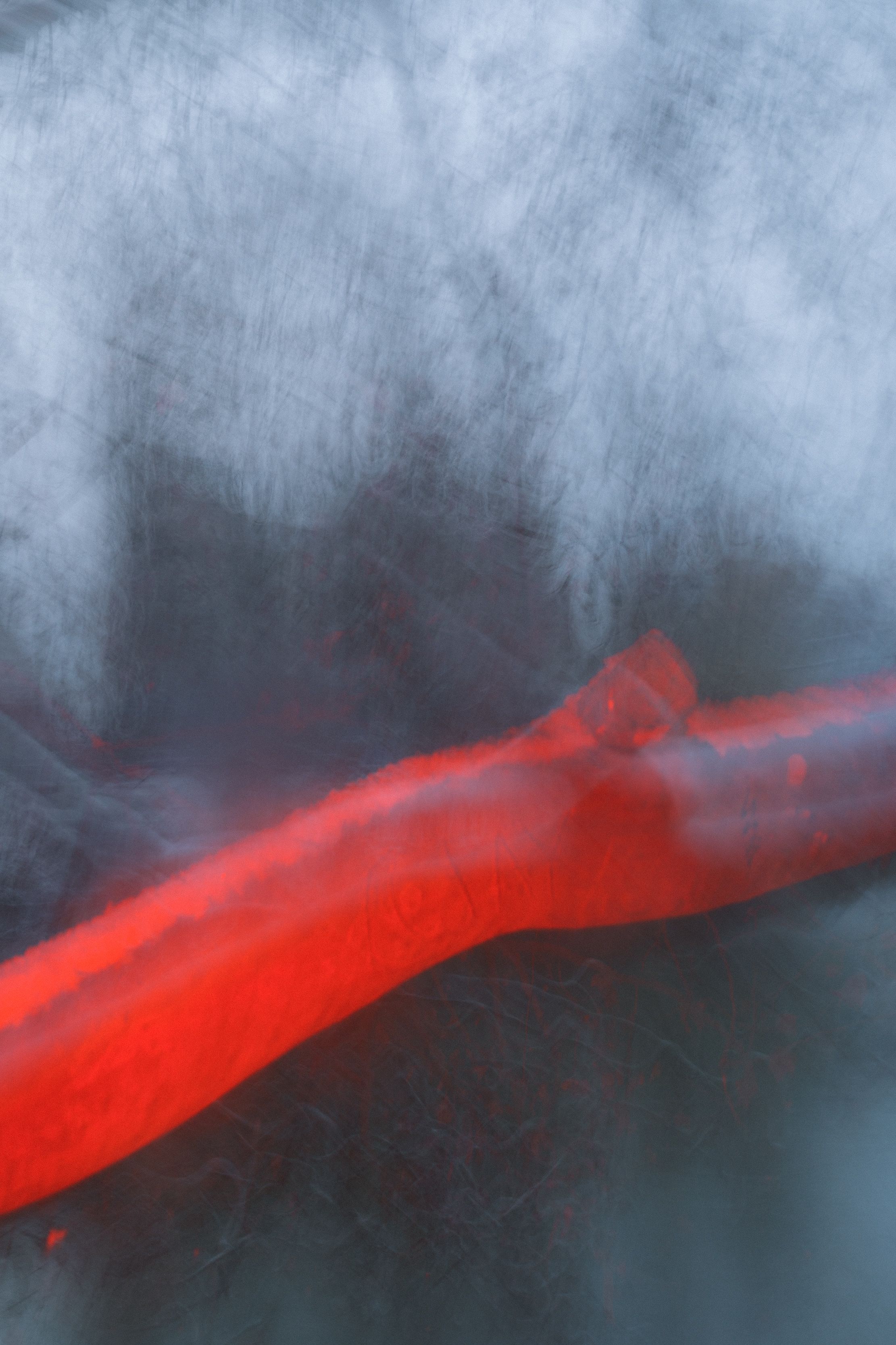 thick red branch blurred background metaphor for pain love 