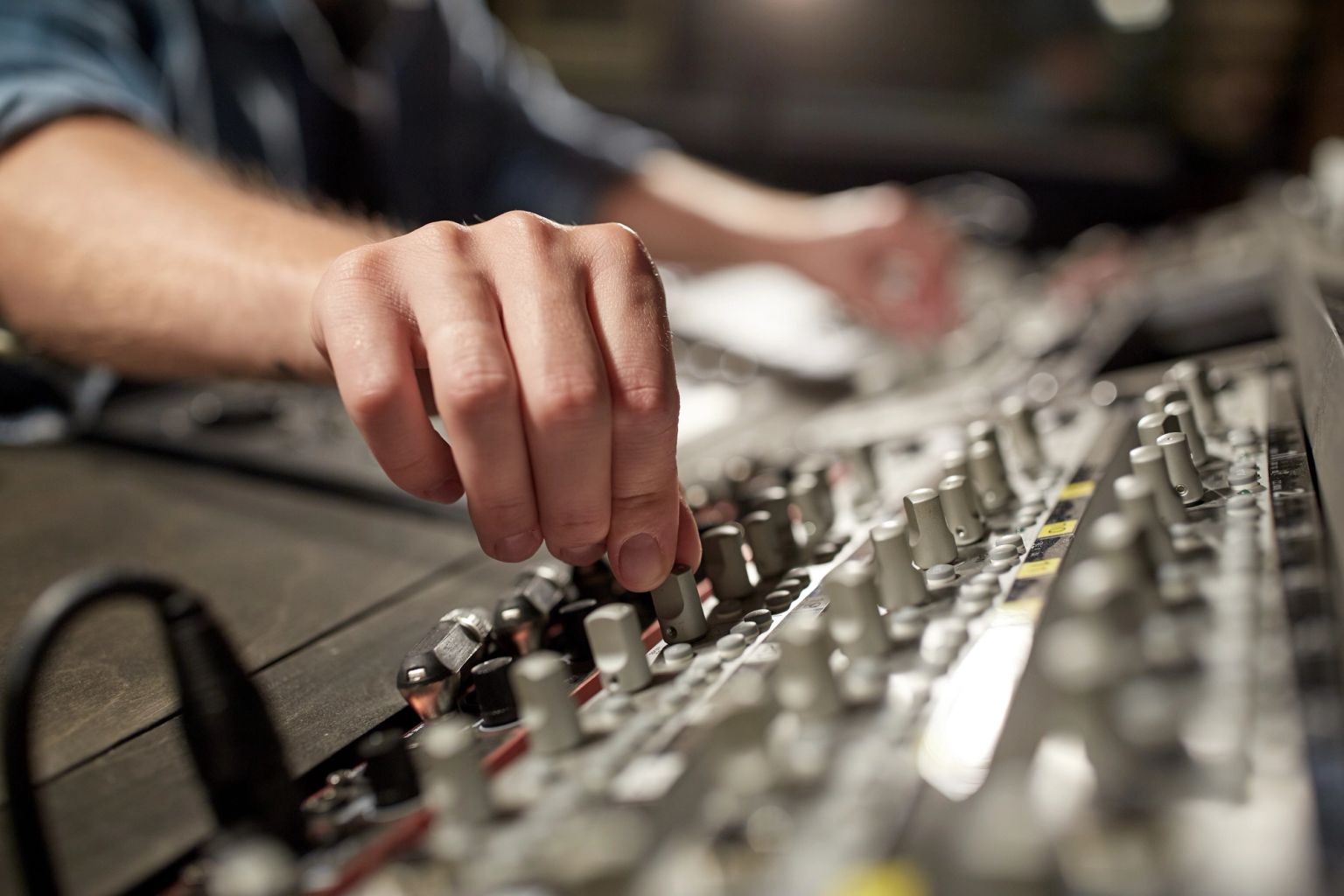 Audio mixing console with multiple faders and knobs