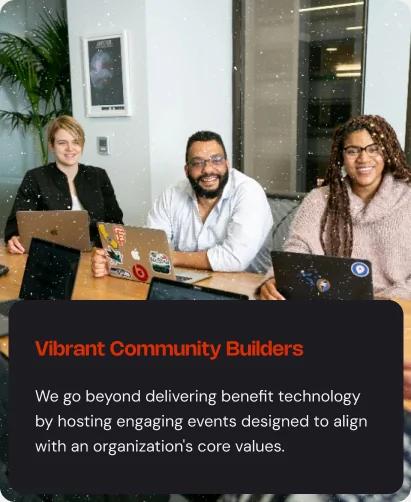 Three colleagues with laptops smiling