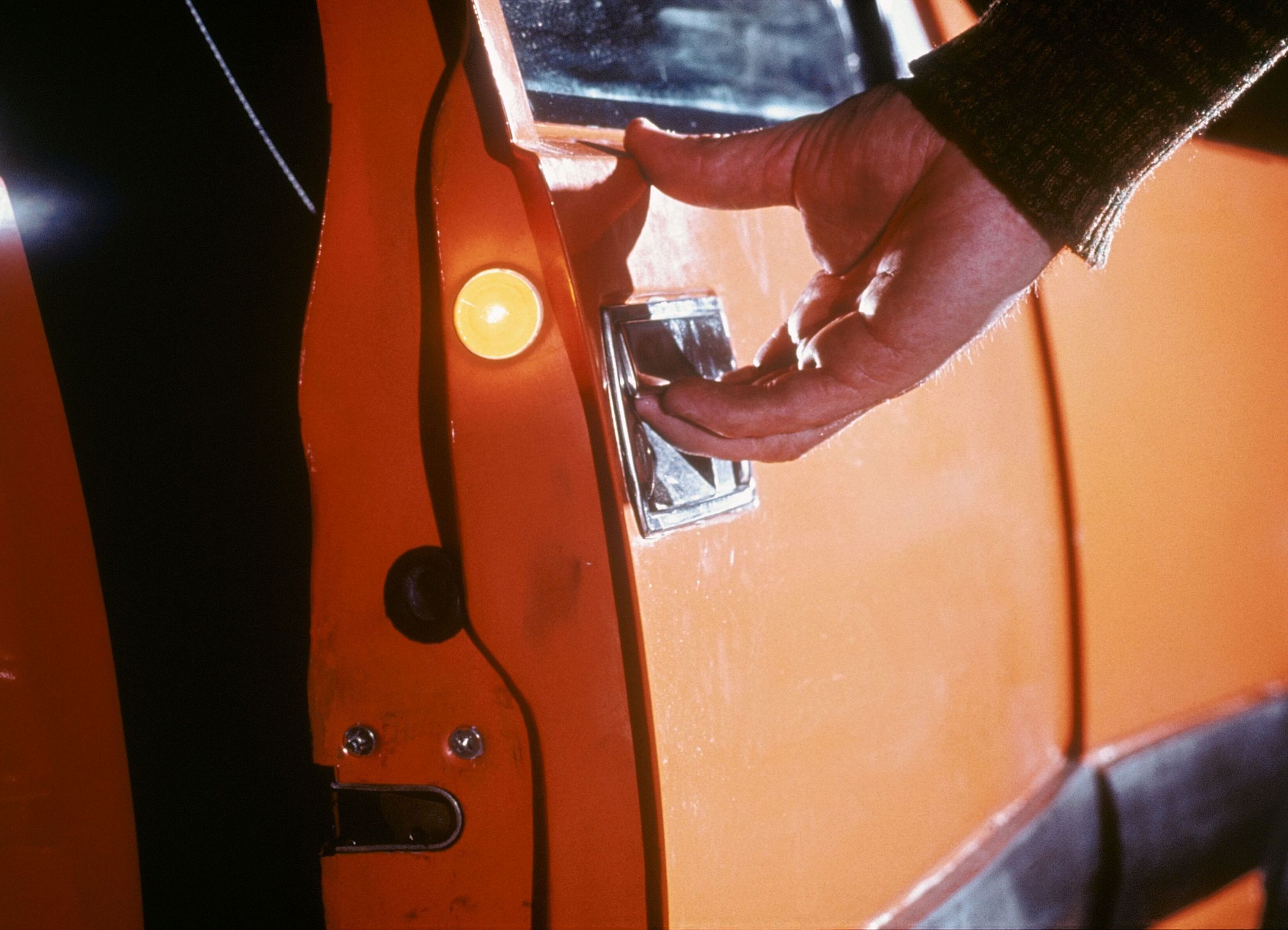 hand opening a car door