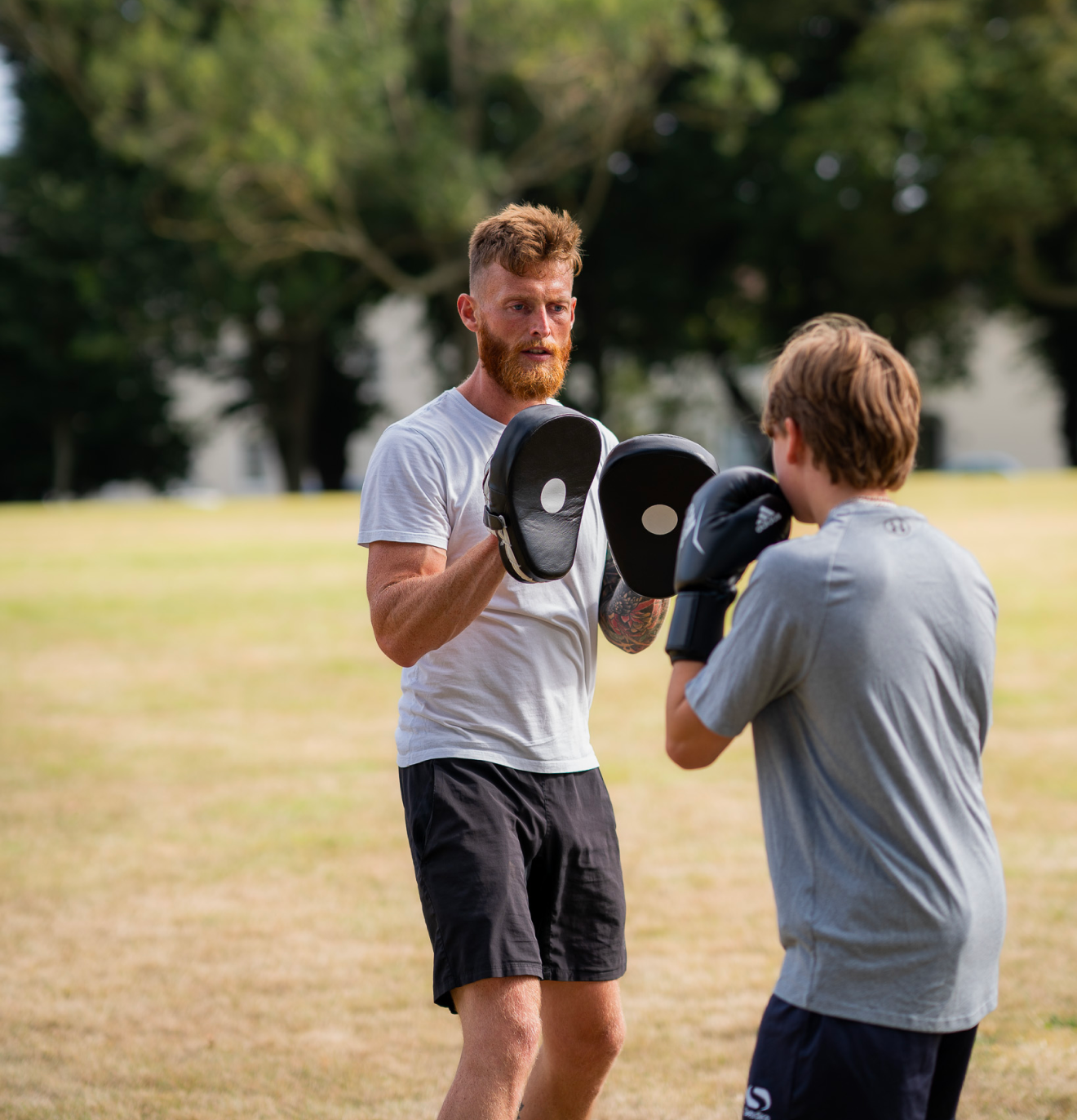 Liam on the boxing pads with the young people