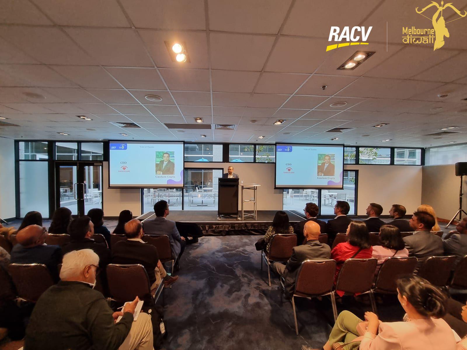 The Launch room at RACV City Club from the back during the vote of thanks, with twin screens above the stage