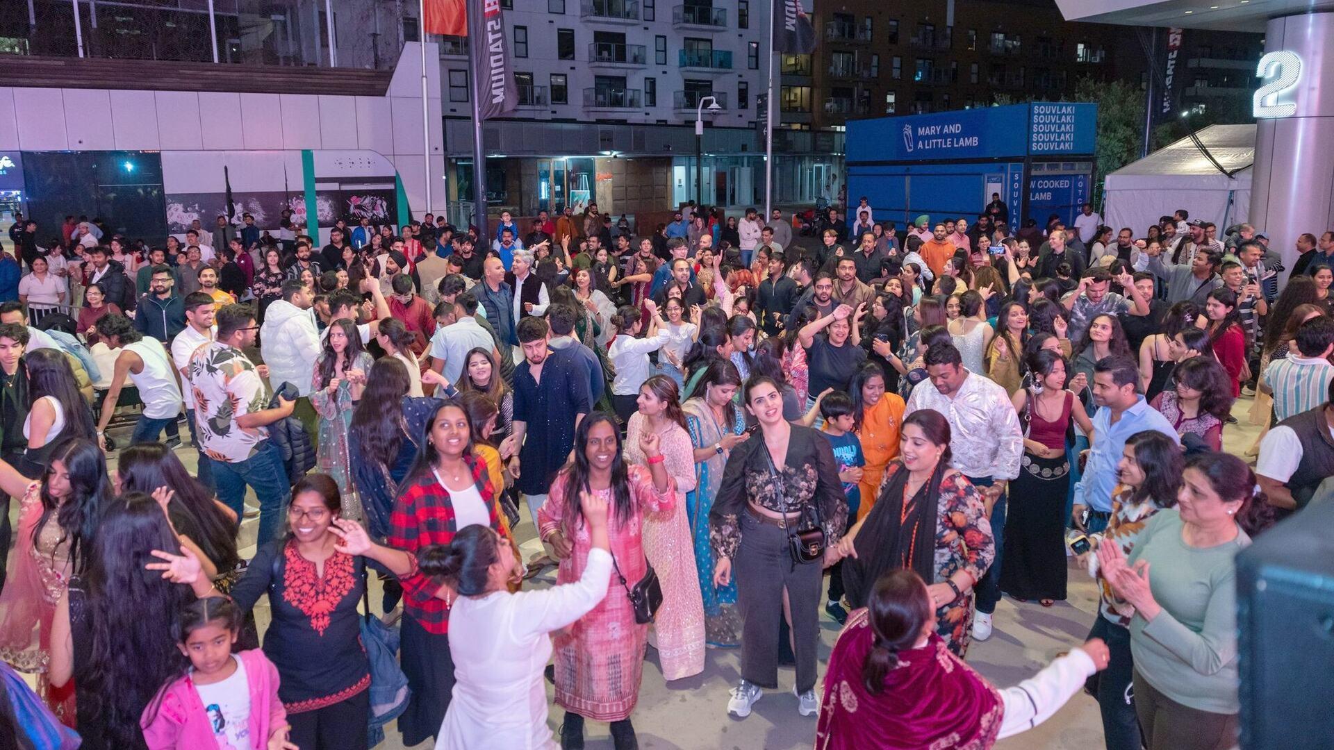 Crowds celebrating Melbourne Diwali at night in Marvel Stadium Square, Docklands