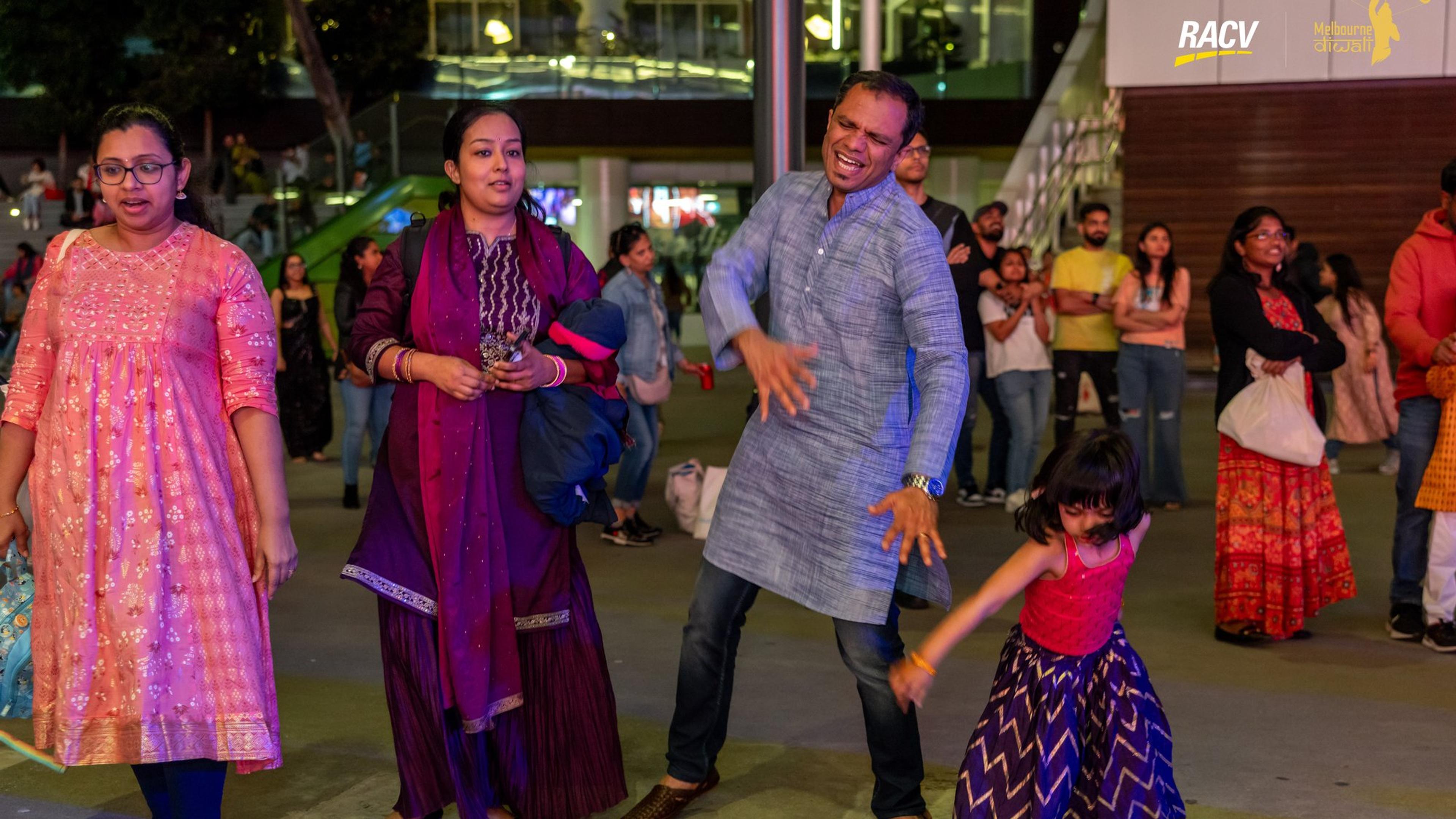A family dancing together at Melbourne Diwali 2024 in Marvel Stadium Square