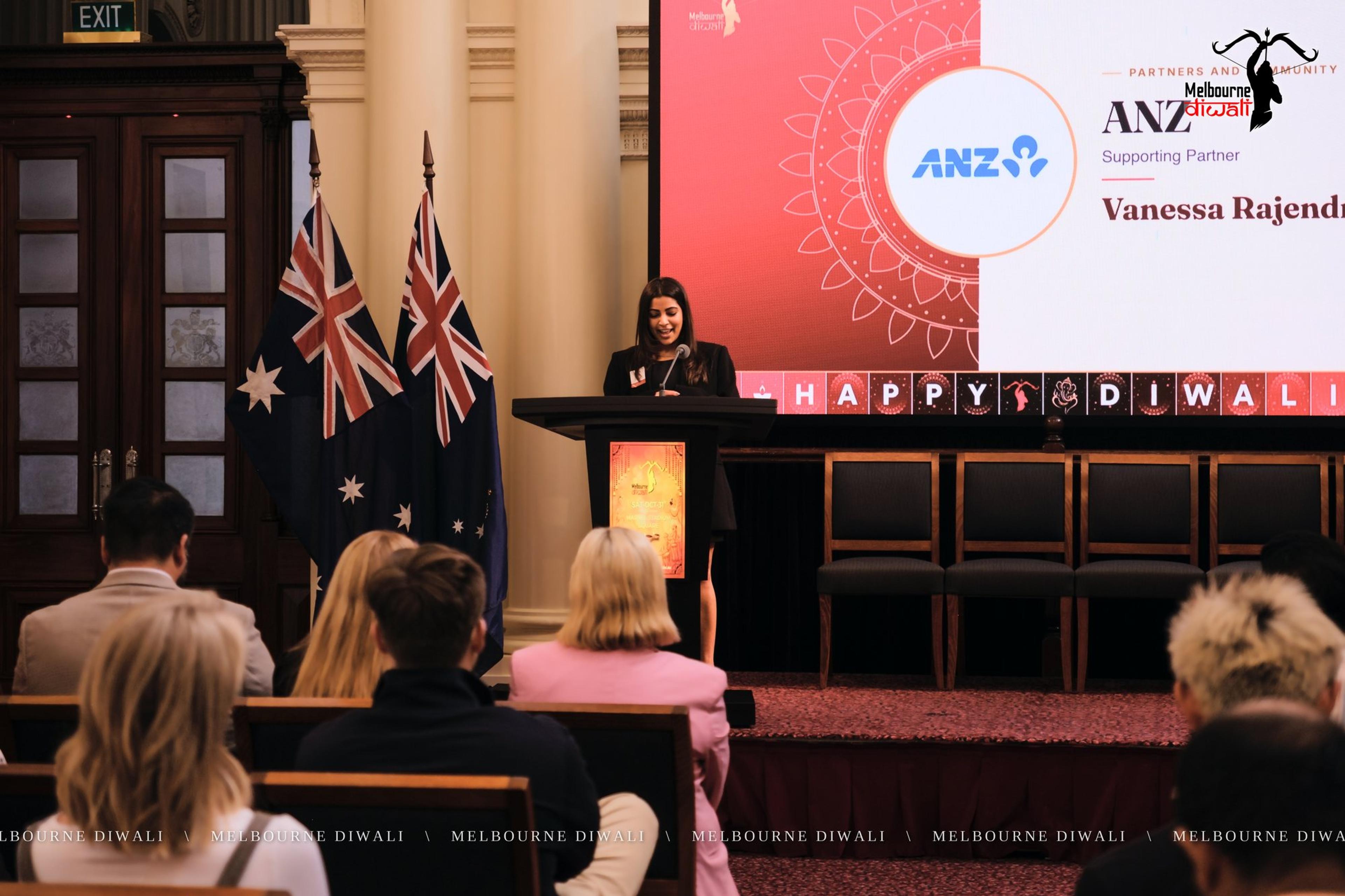 Vanessa Rajendram speaks for ANZ beside the ANZ slide