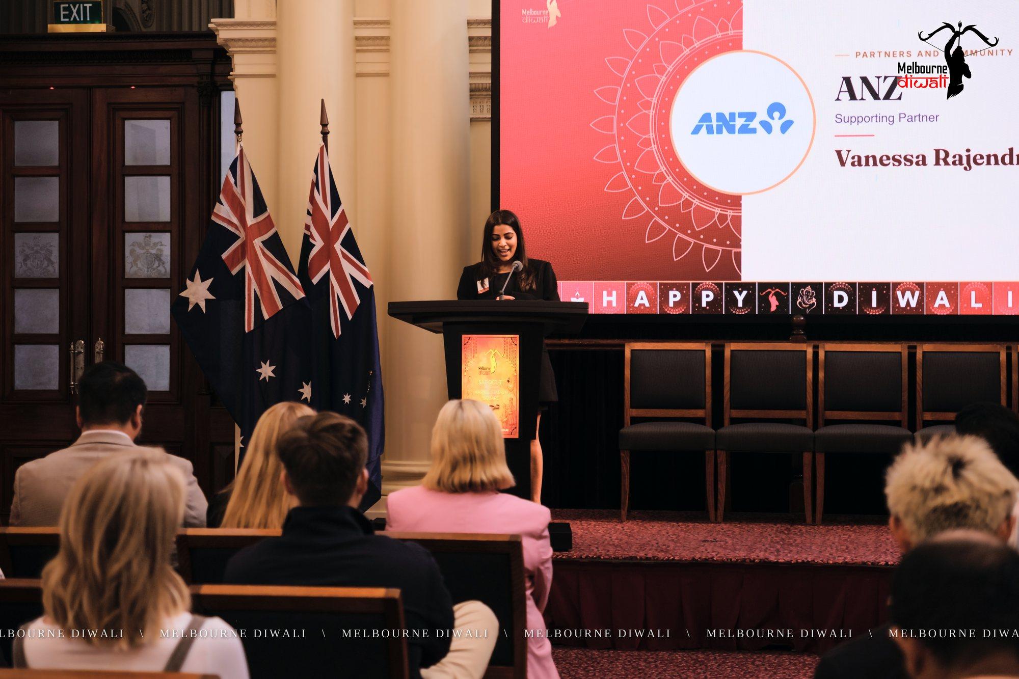Vanessa Rajendram speaks for ANZ beside the ANZ slide