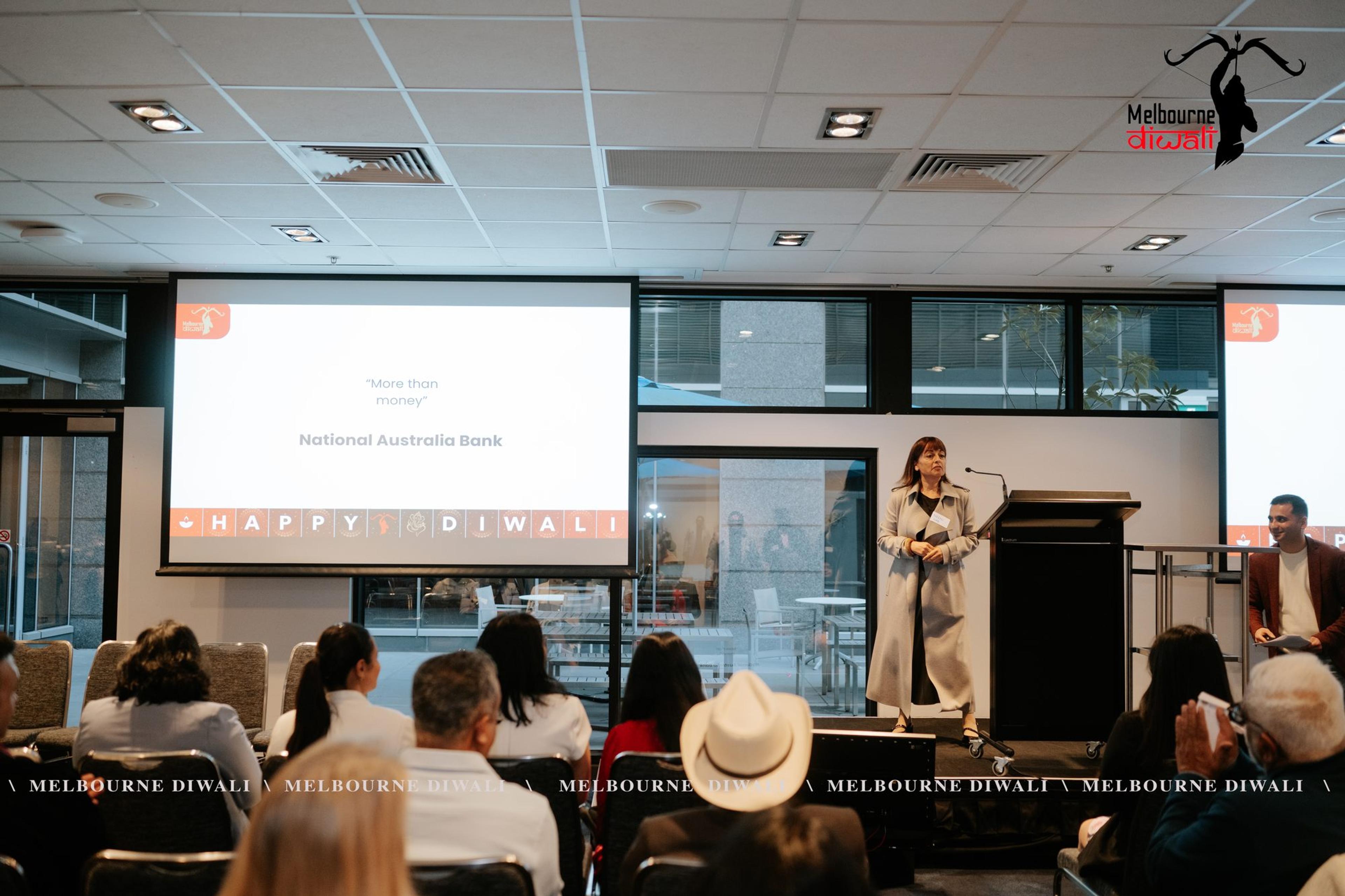 A National Australia Bank presentation, with the slide 'More than money' on screen above the seated audience
