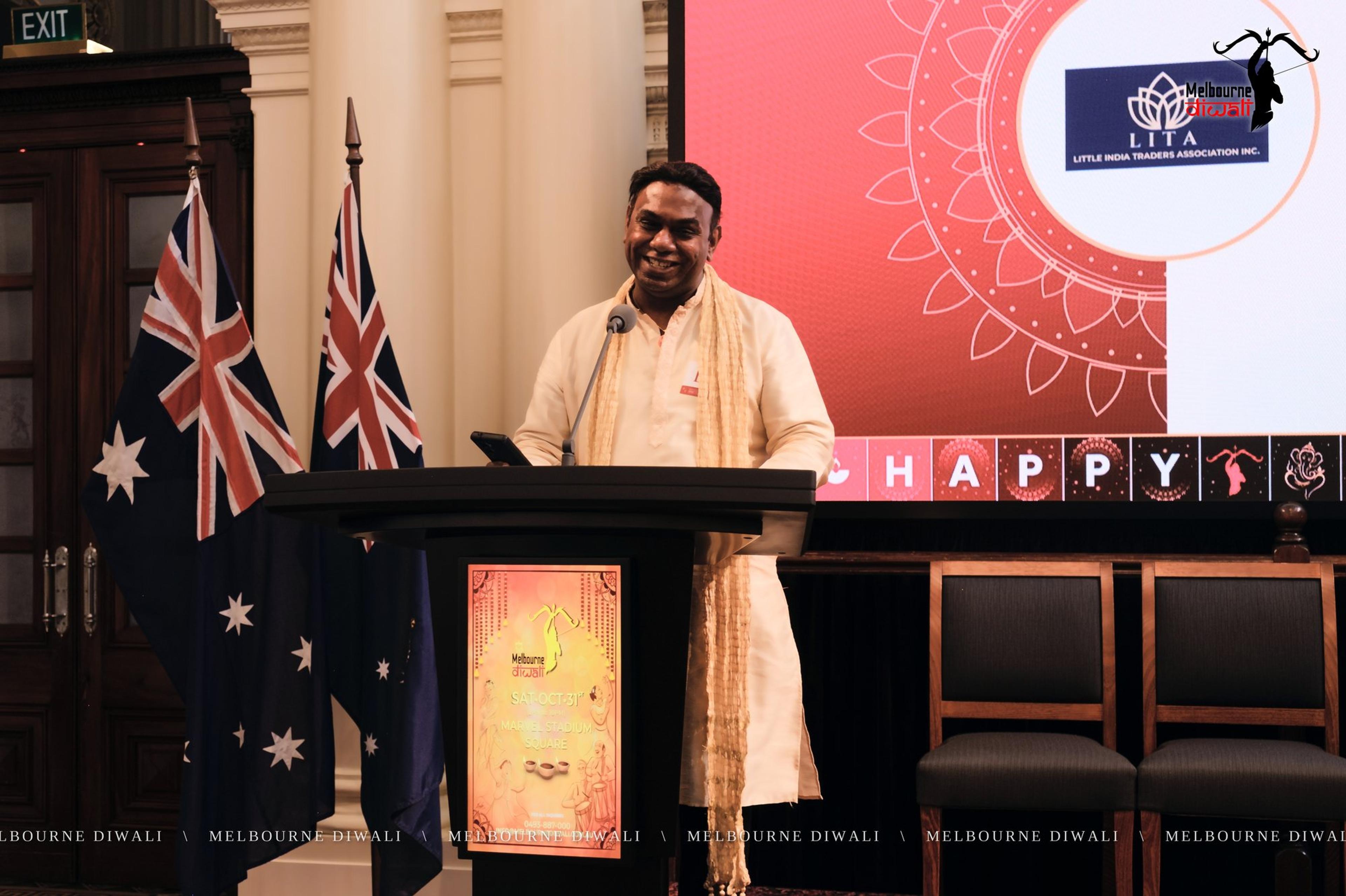 Praveen Kumar Komaragiri speaks for the Little India Traders Association beside the LITA slide