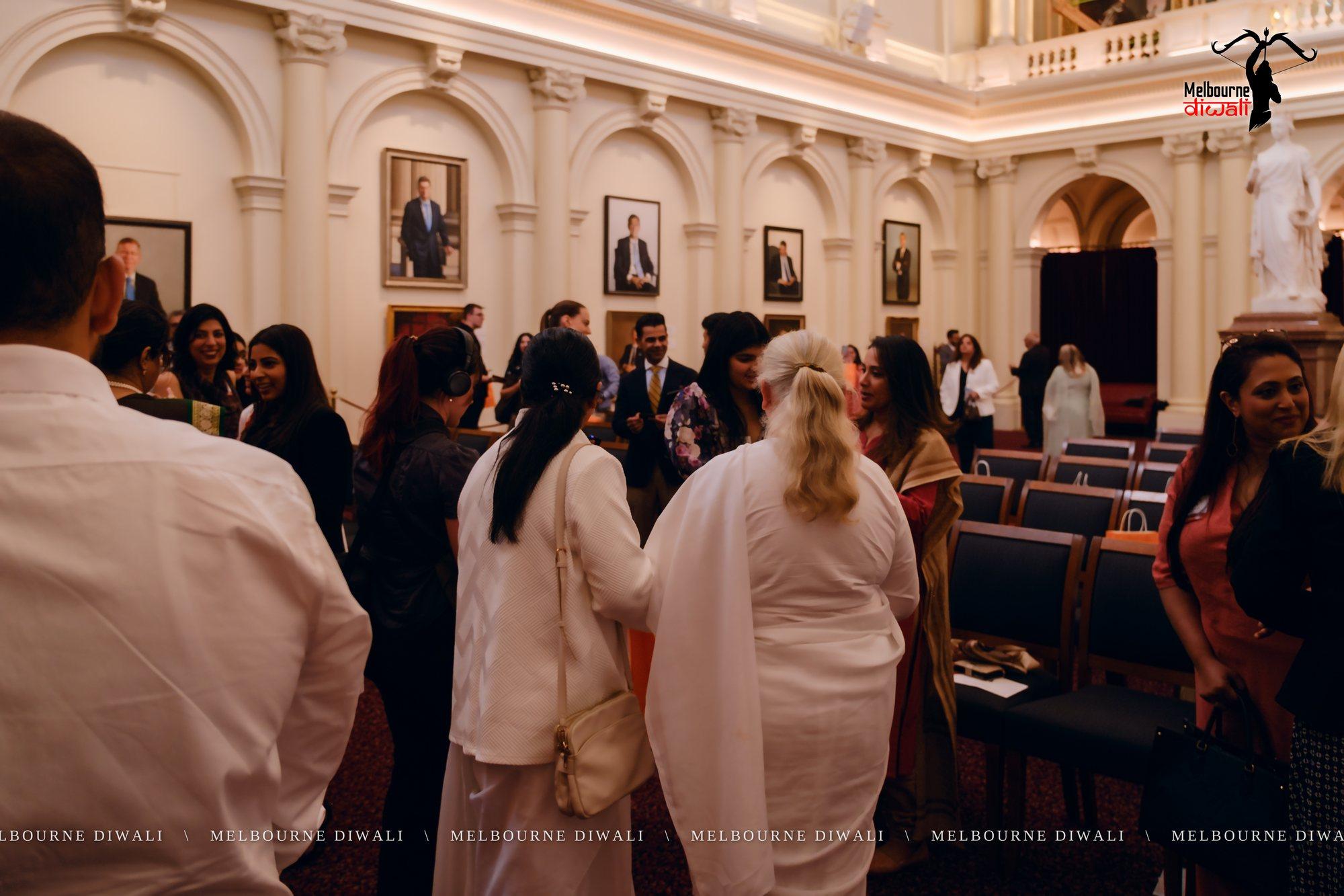 Guests talk in Queen's Hall during networking