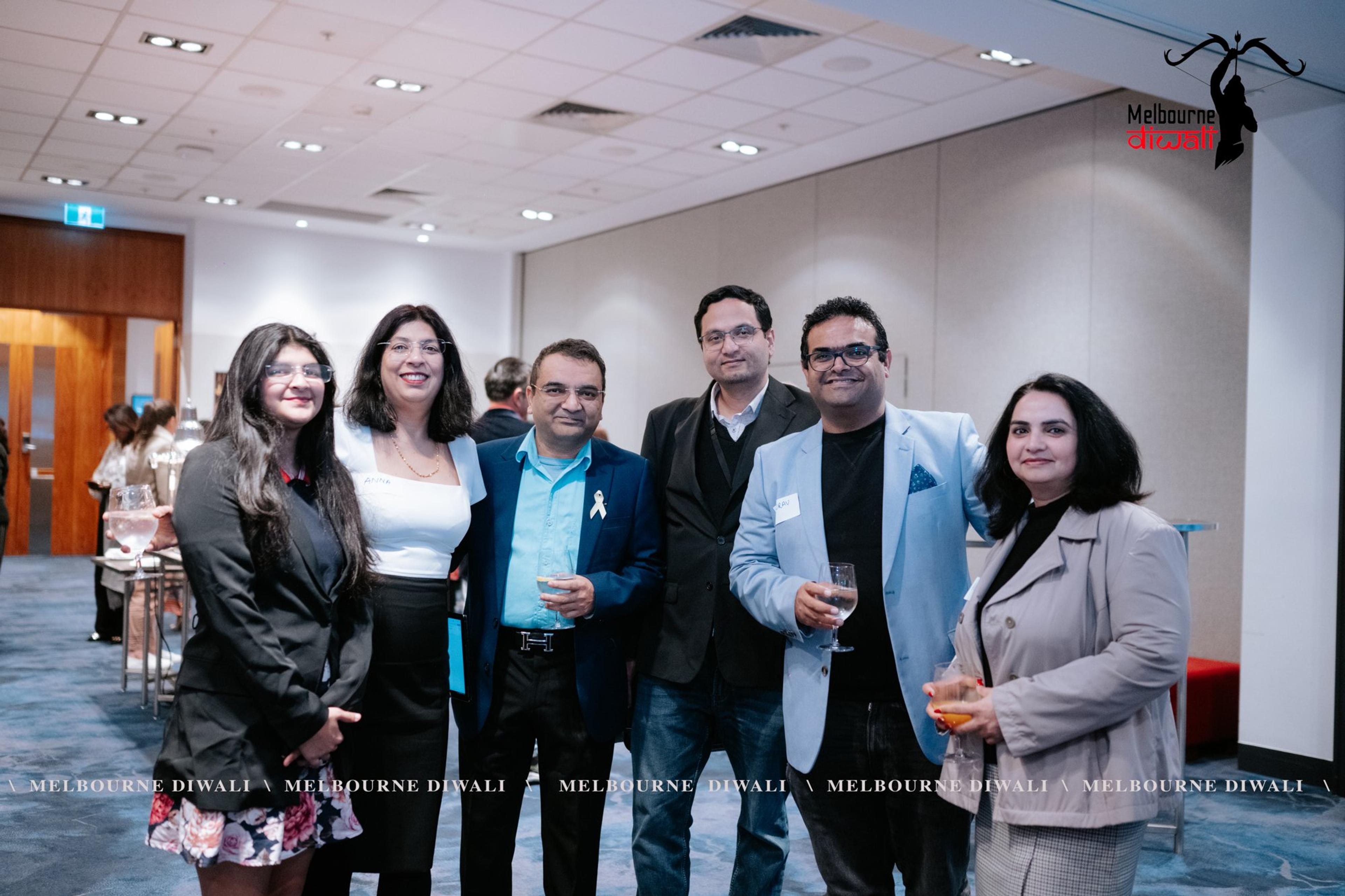 Six guests pose together in the Launch room