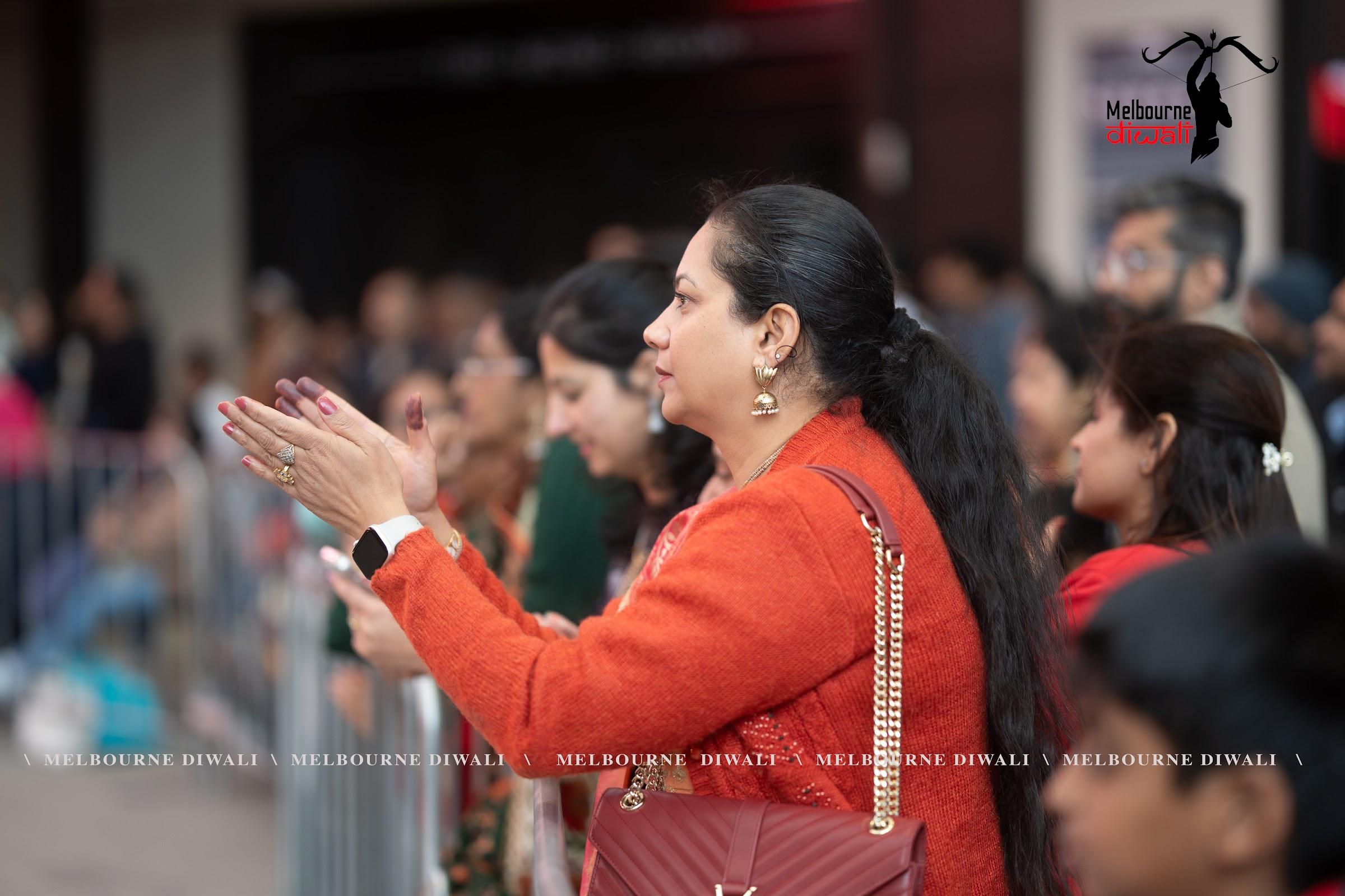An audience member applauds a performance at Melbourne Diwali 2025