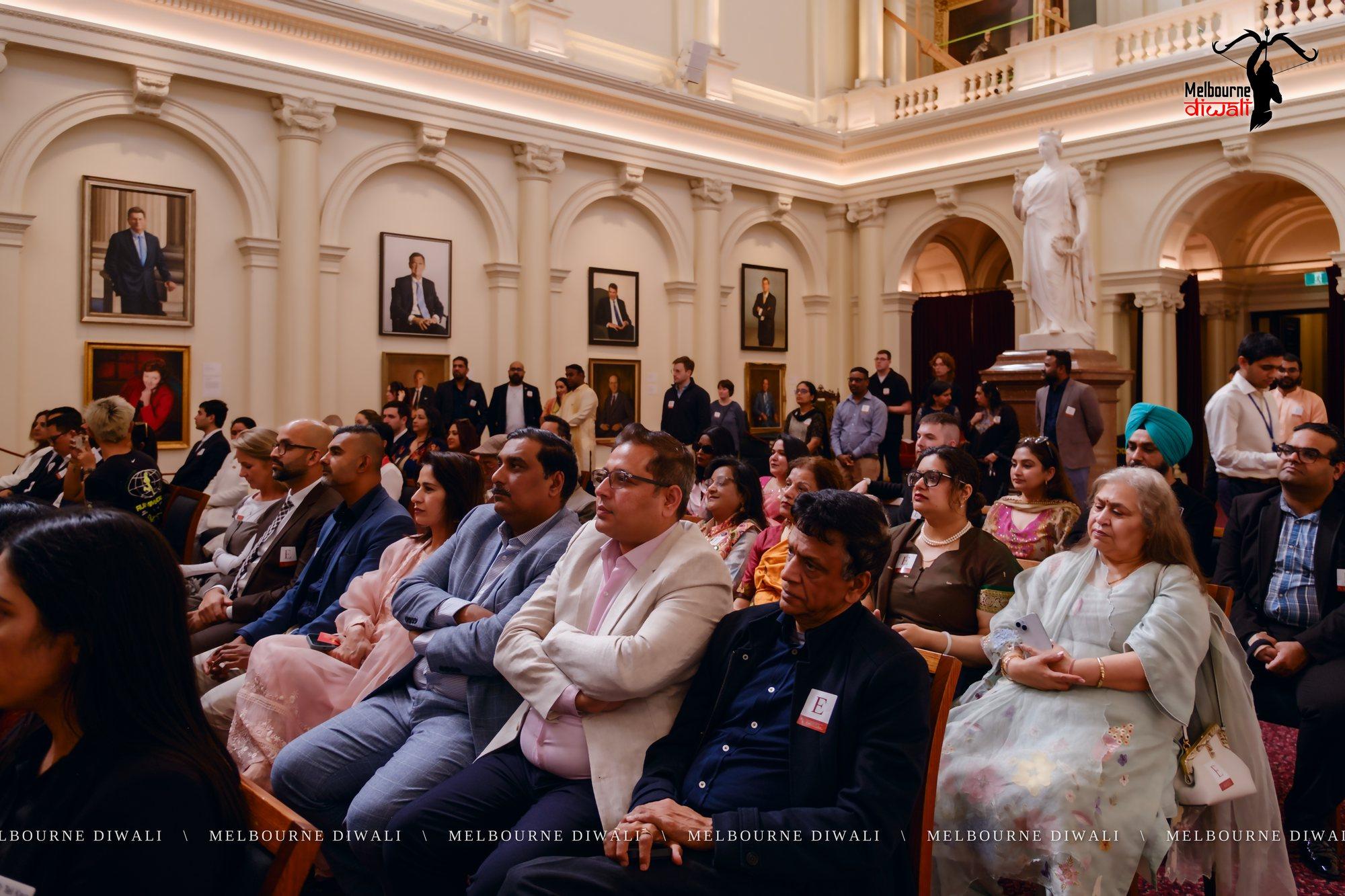 Guests in the audience listen to a speaker