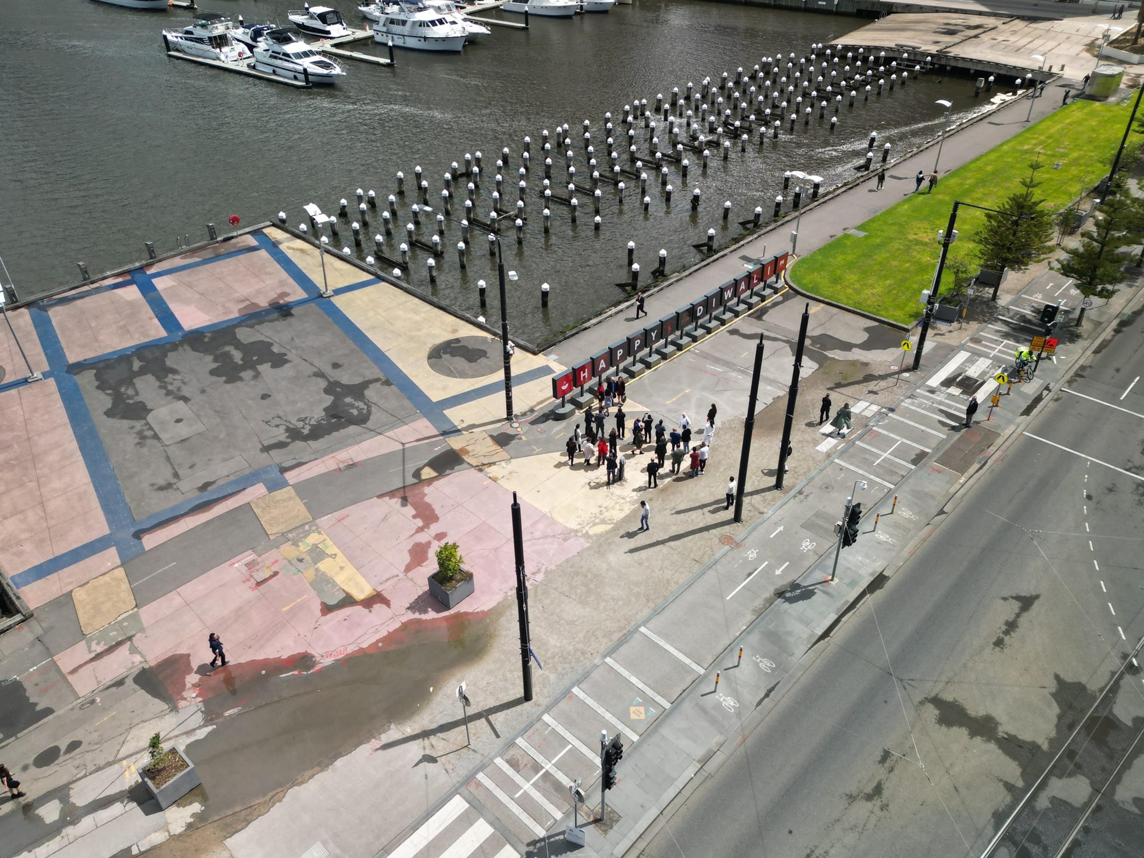 A drone view of guests gathered at the HAPPY DIWALI sign on Harbour Esplanade, beside the marina