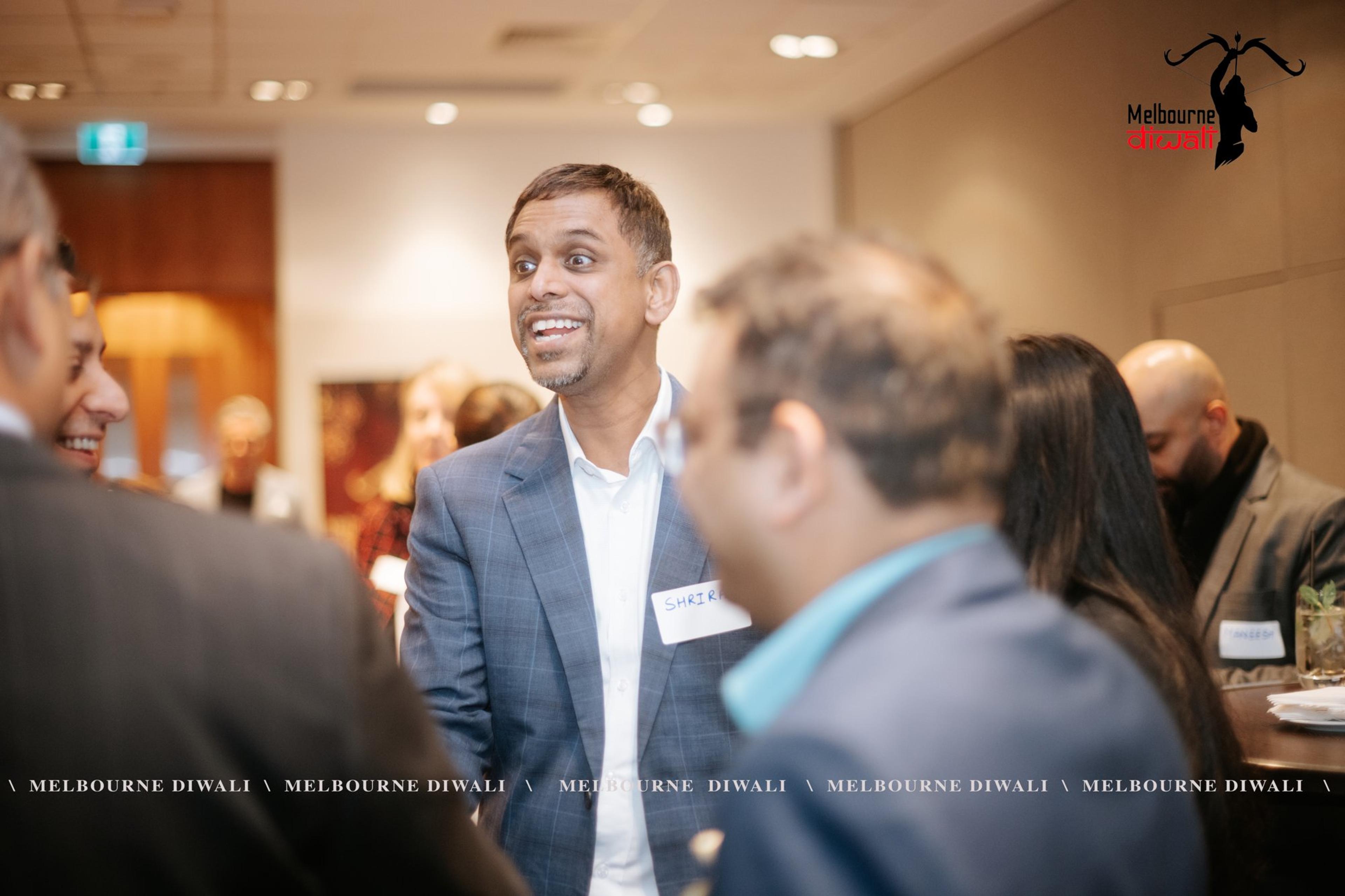 Guests with name badges share a laugh during networking at RACV City Club