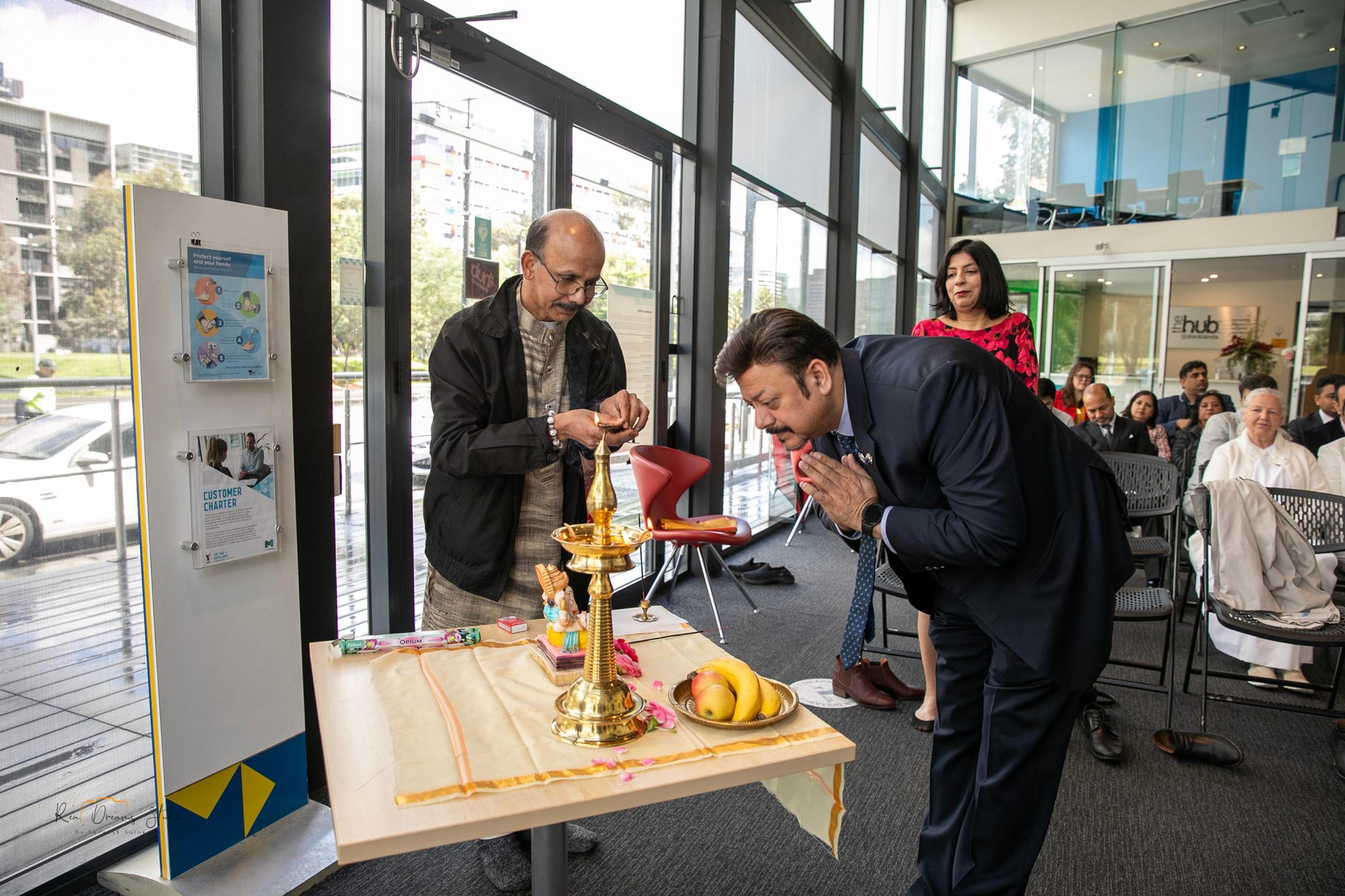 A guest bows at the lamp during the lamp lighting