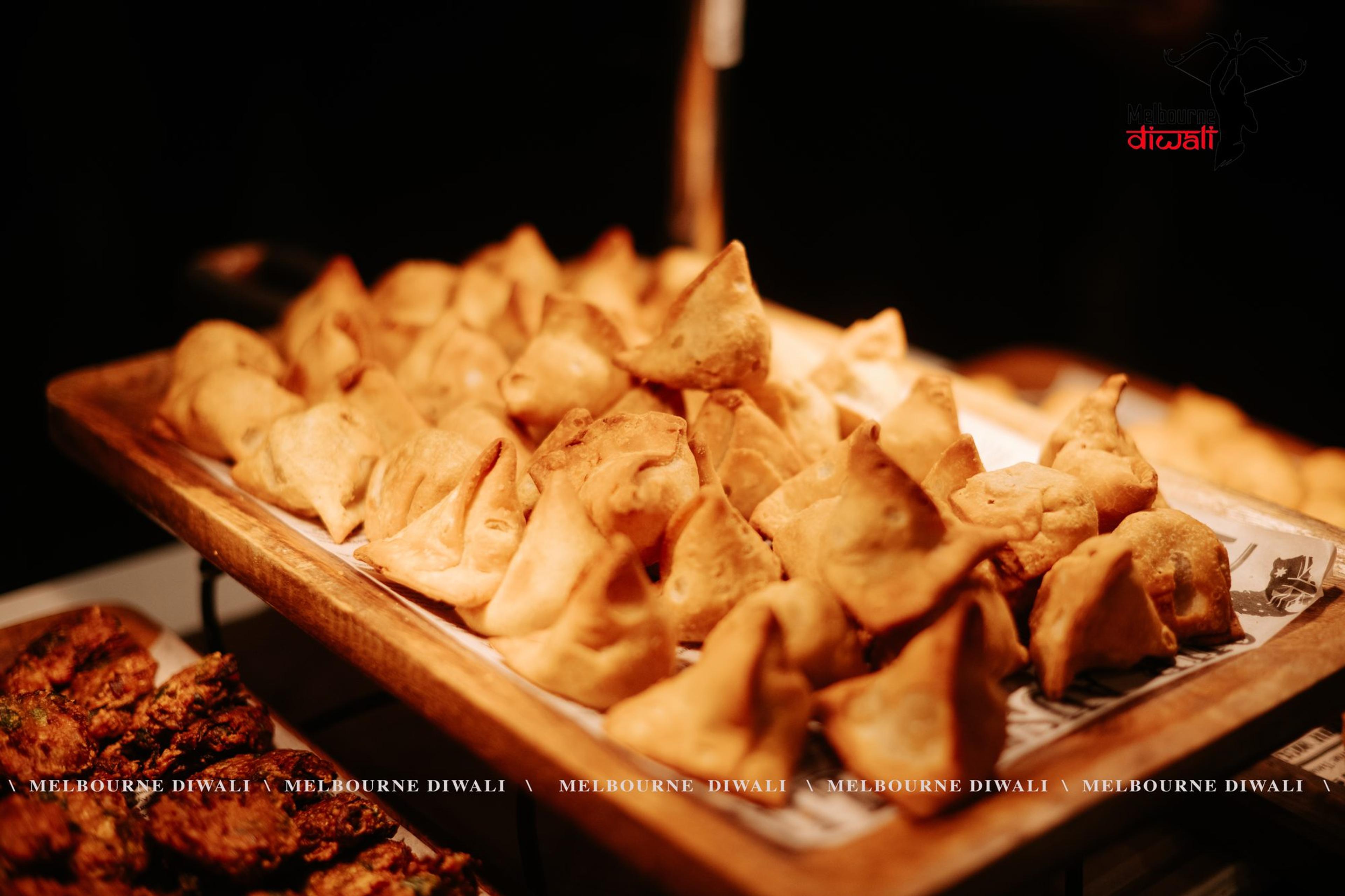 A tray of golden samosas served to guests