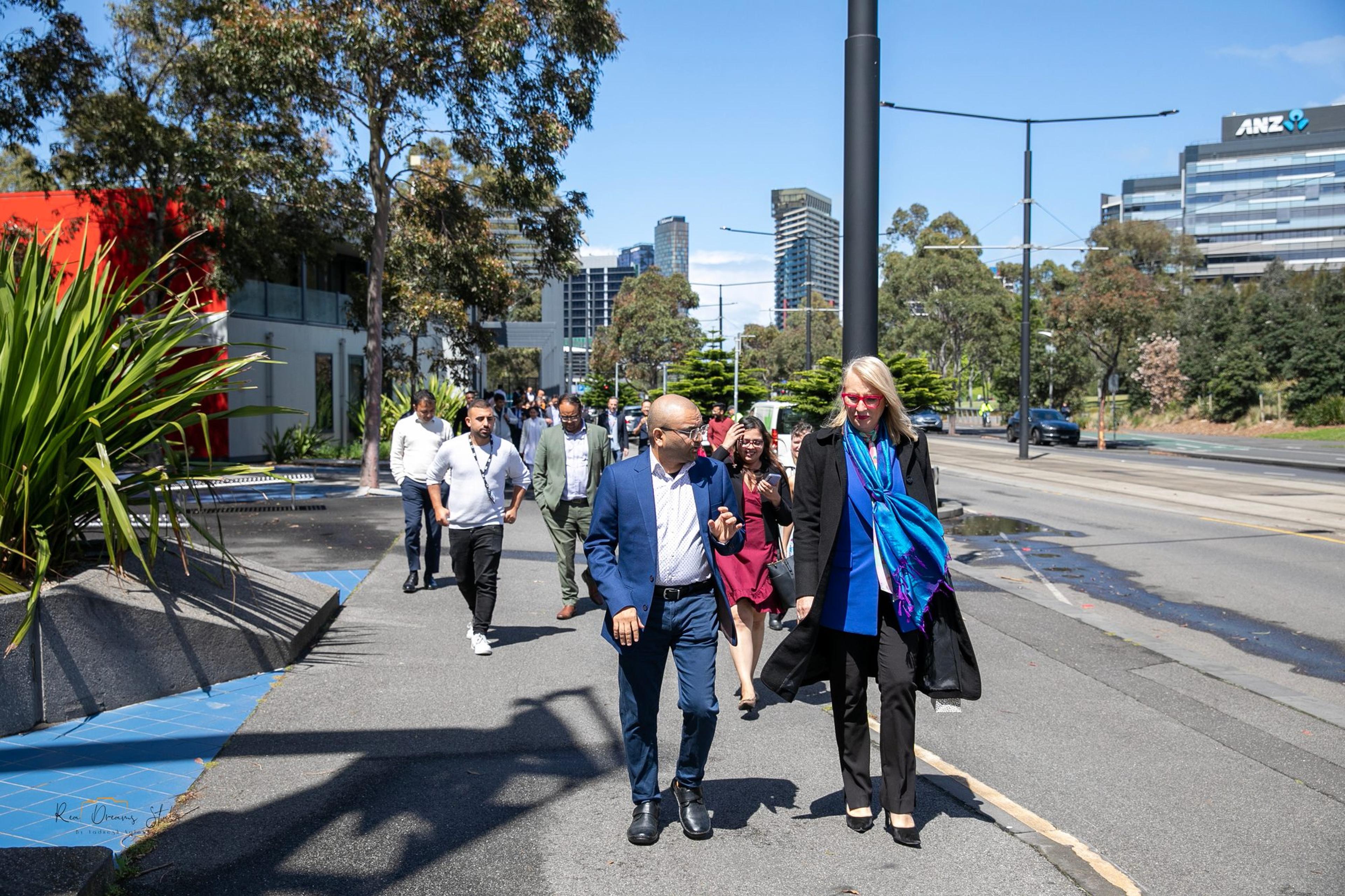 Guests walk from The Hub towards Harbour Esplanade