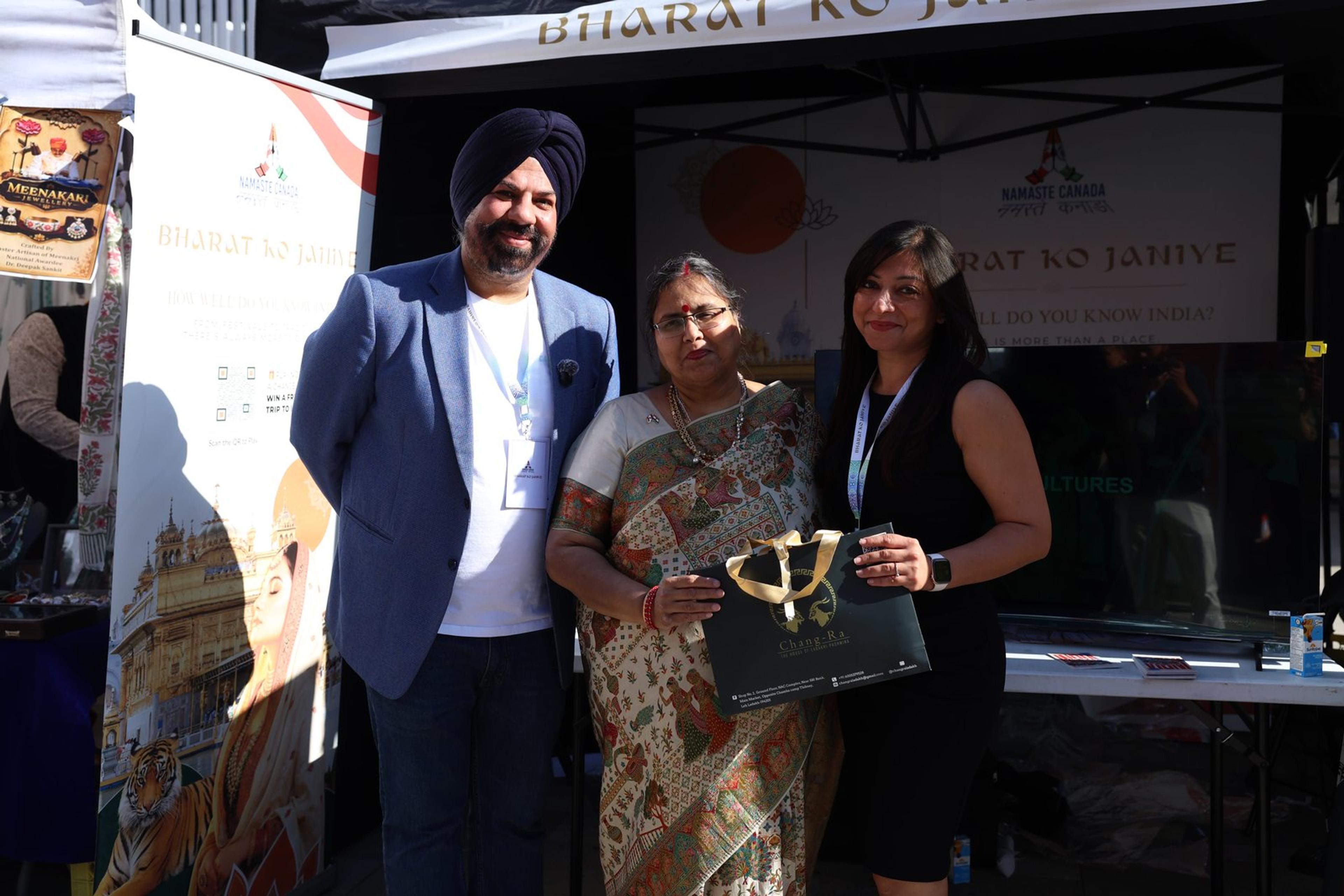 A visitor receives a giveaway at the Bharat Ko Janiye stall