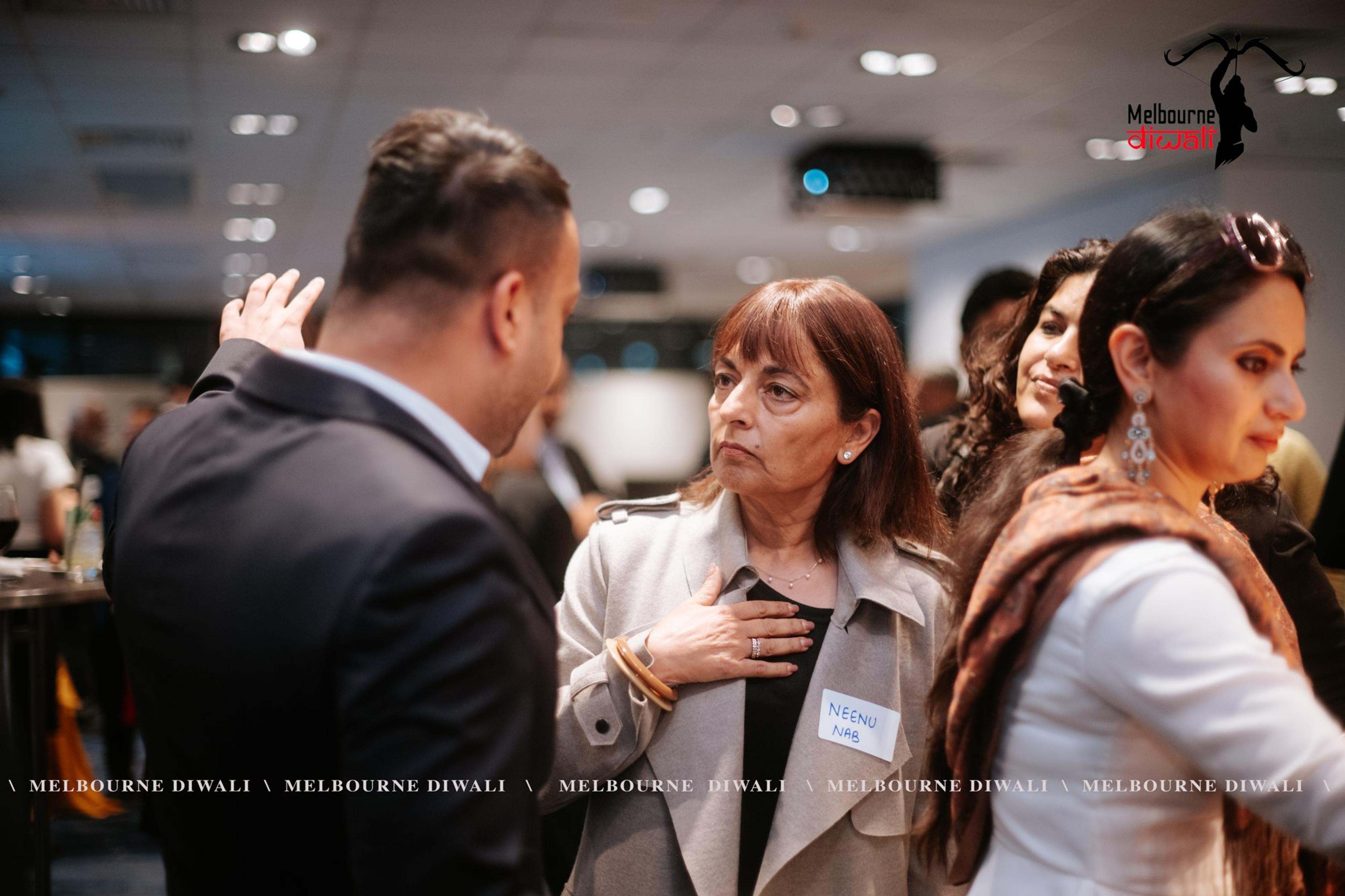 Guests greet each other during networking