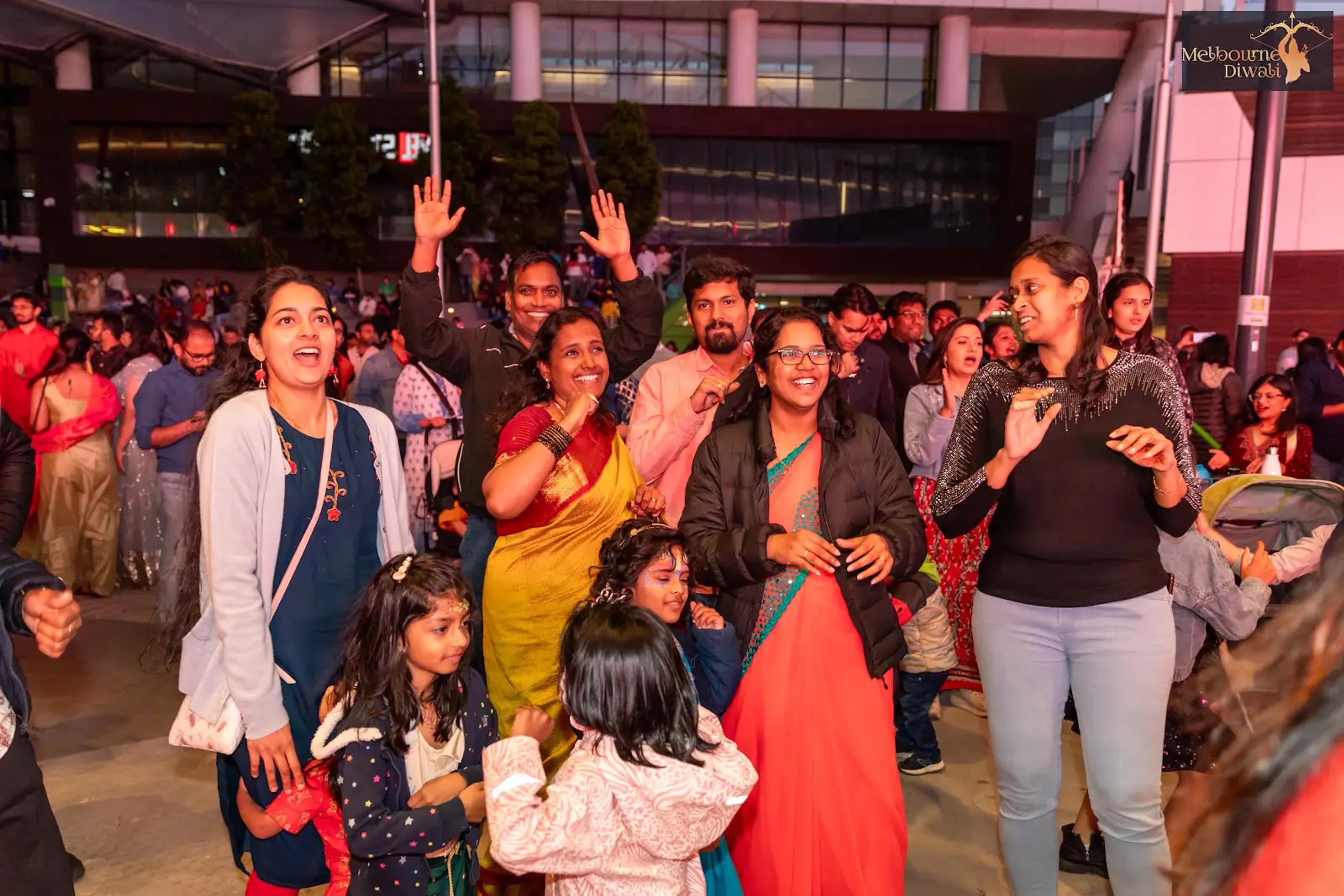 Adults and children dancing in traditional and casual clothing at Melbourne Diwali 2023