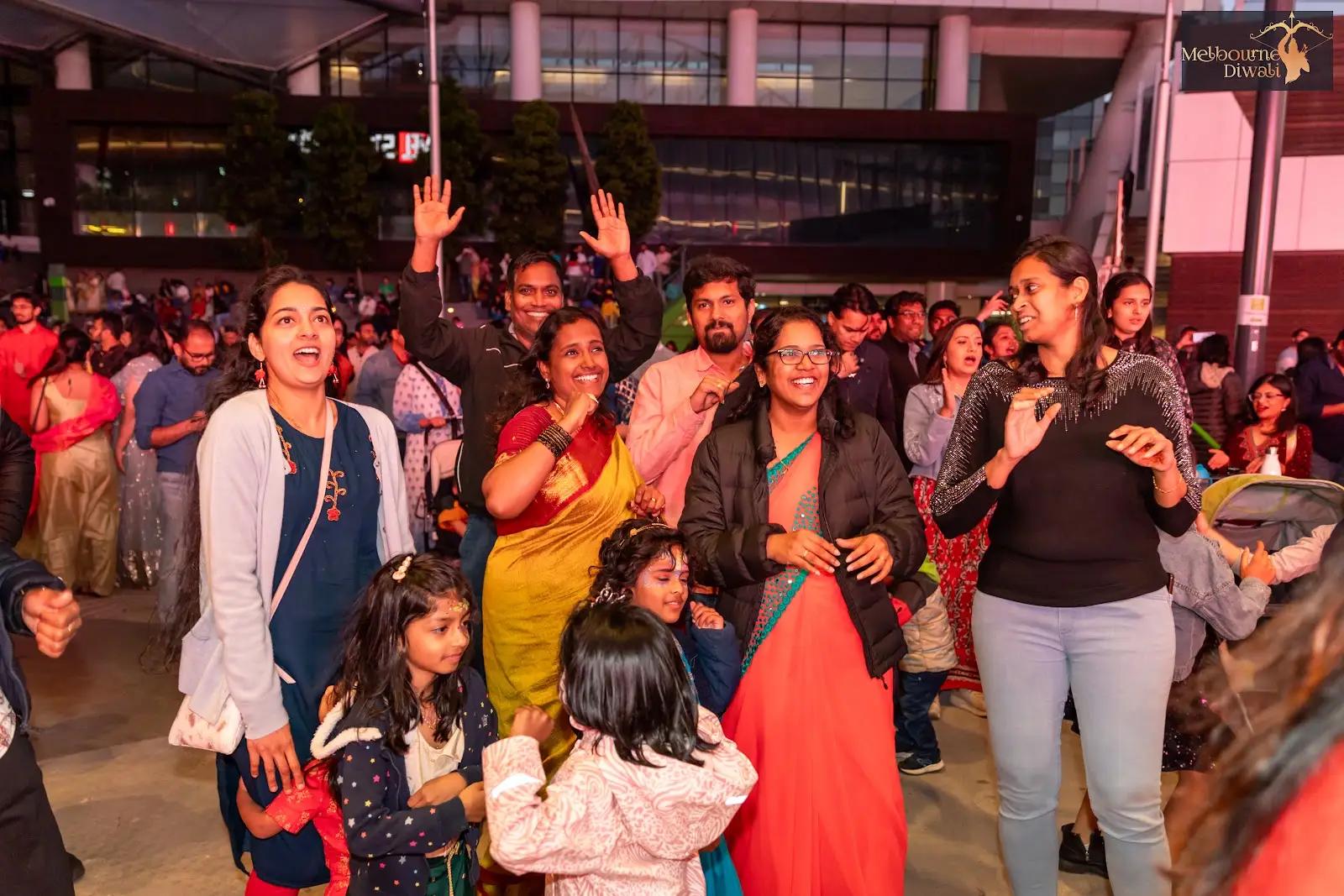 Adults and children dancing in traditional and casual clothing at Melbourne Diwali 2023