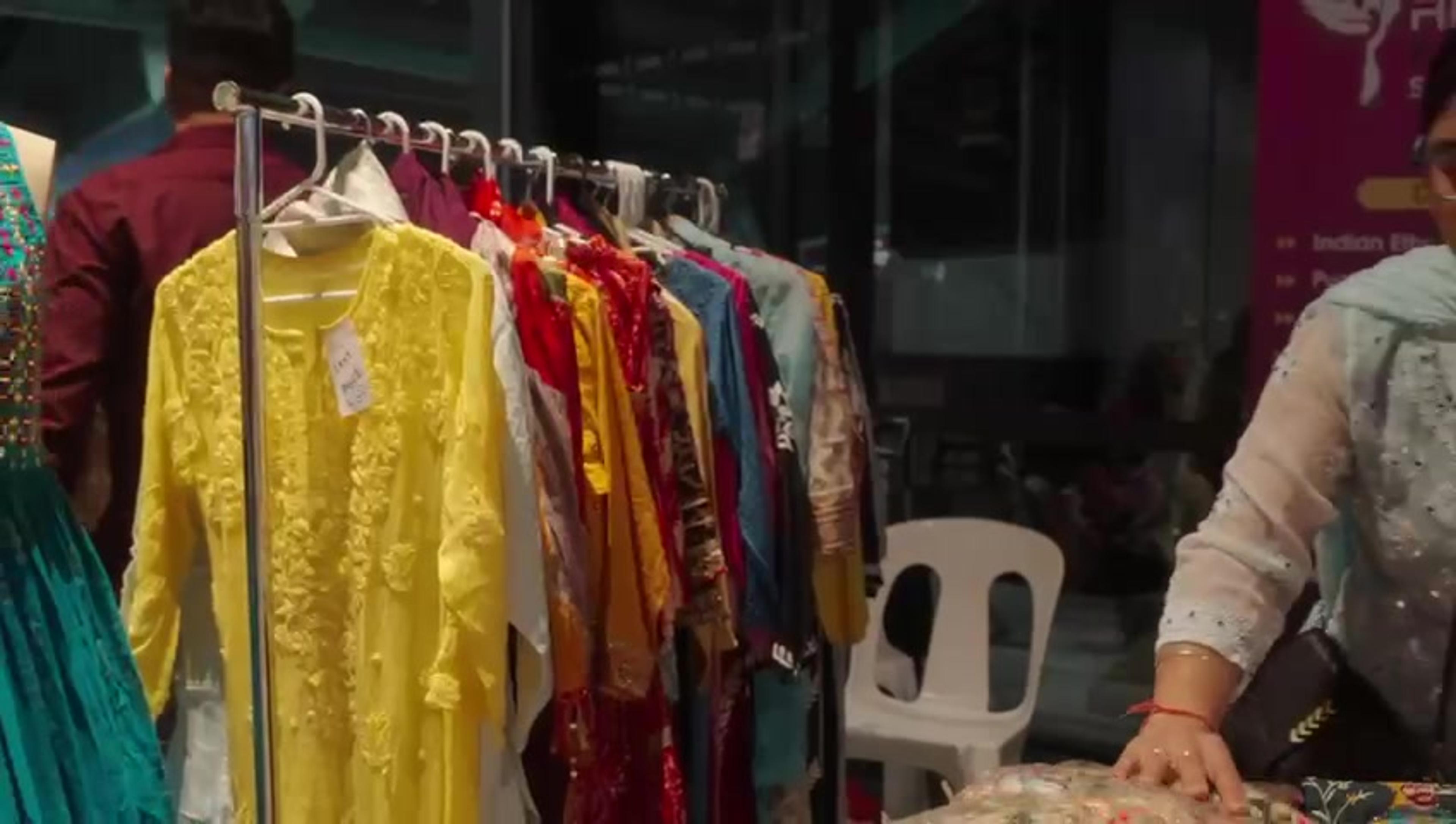 A clothing stall with embroidered kurtas on a rail at Melbourne Diwali 2023