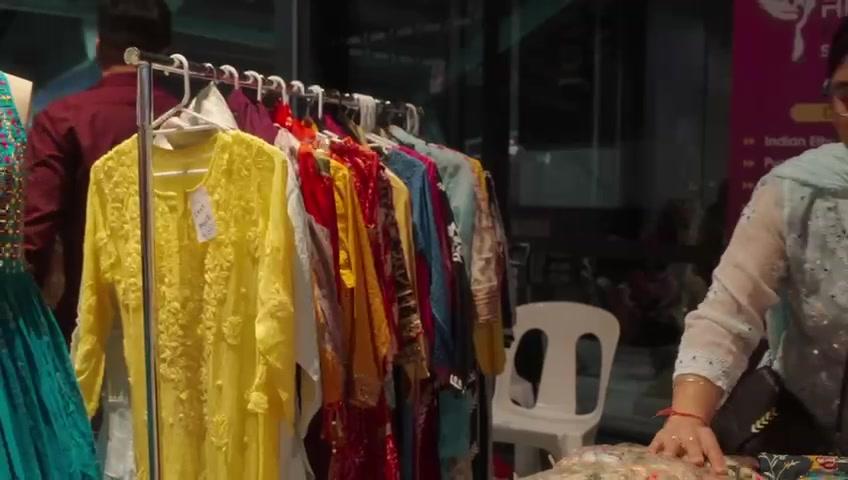A clothing stall with embroidered kurtas on a rail at Melbourne Diwali 2023