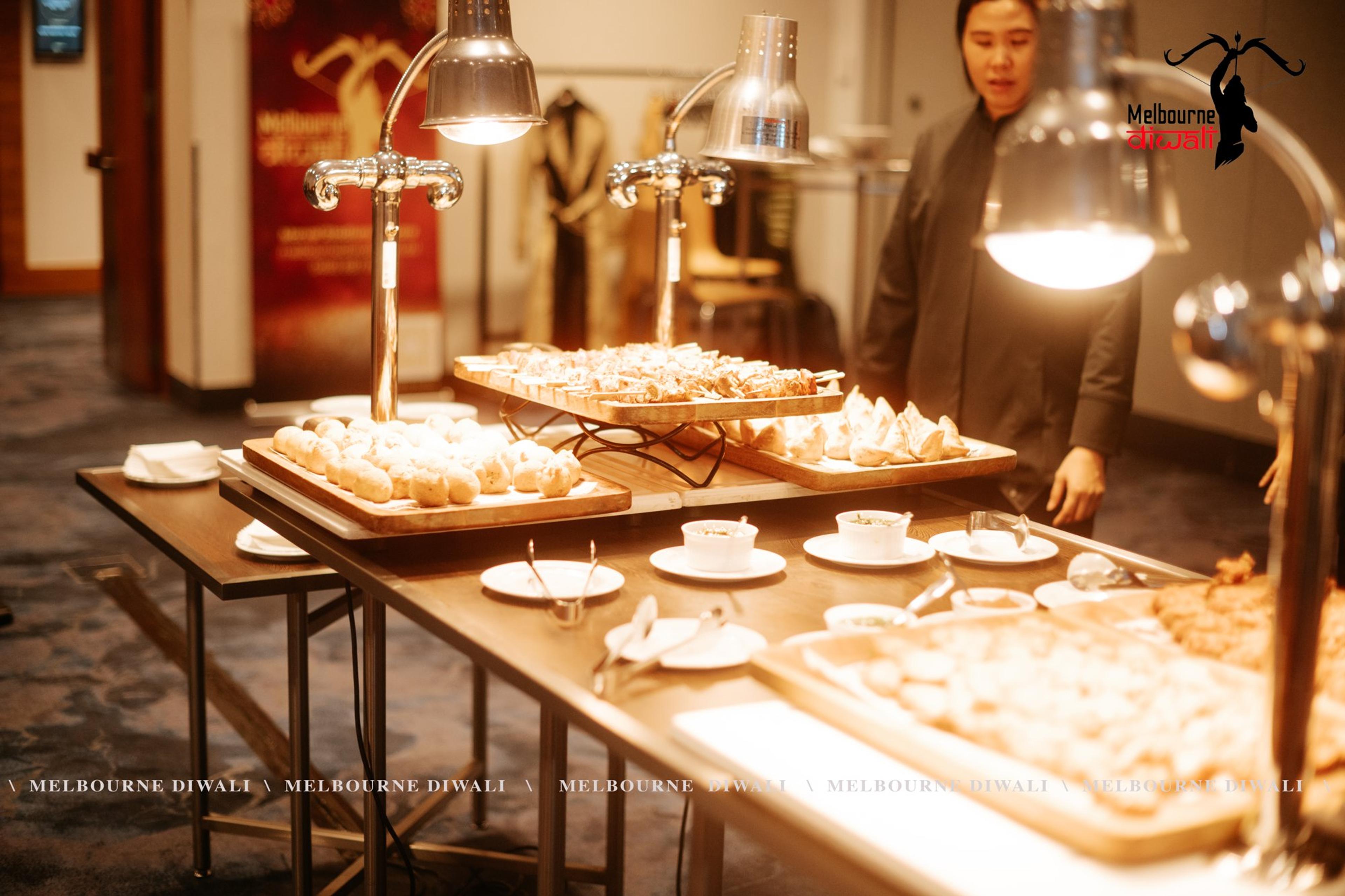 Trays of finger food under warming lamps at the Launch