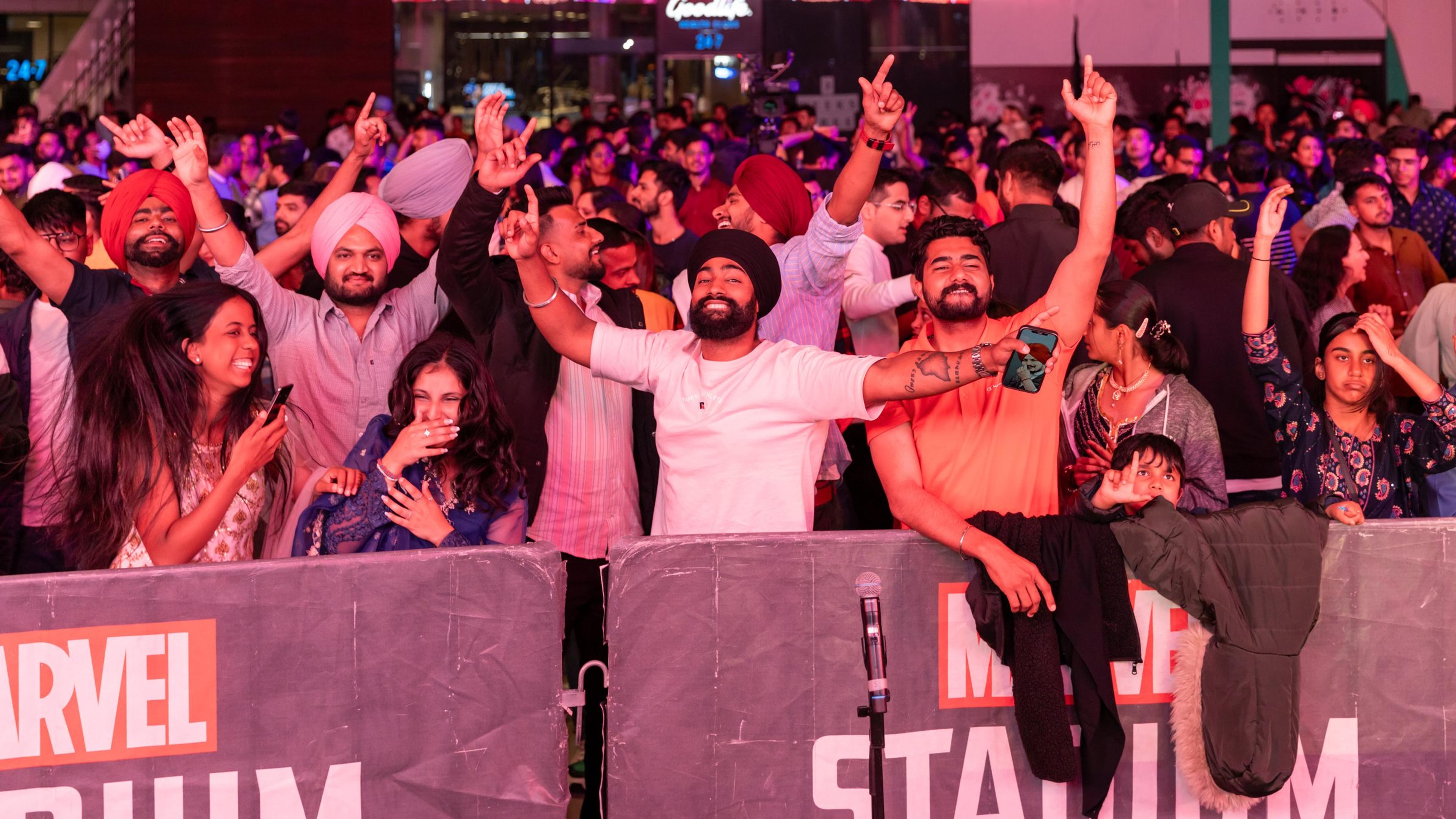 Festival-goers cheering at the front barrier during an evening performance at Melbourne Diwali, Marvel Stadium