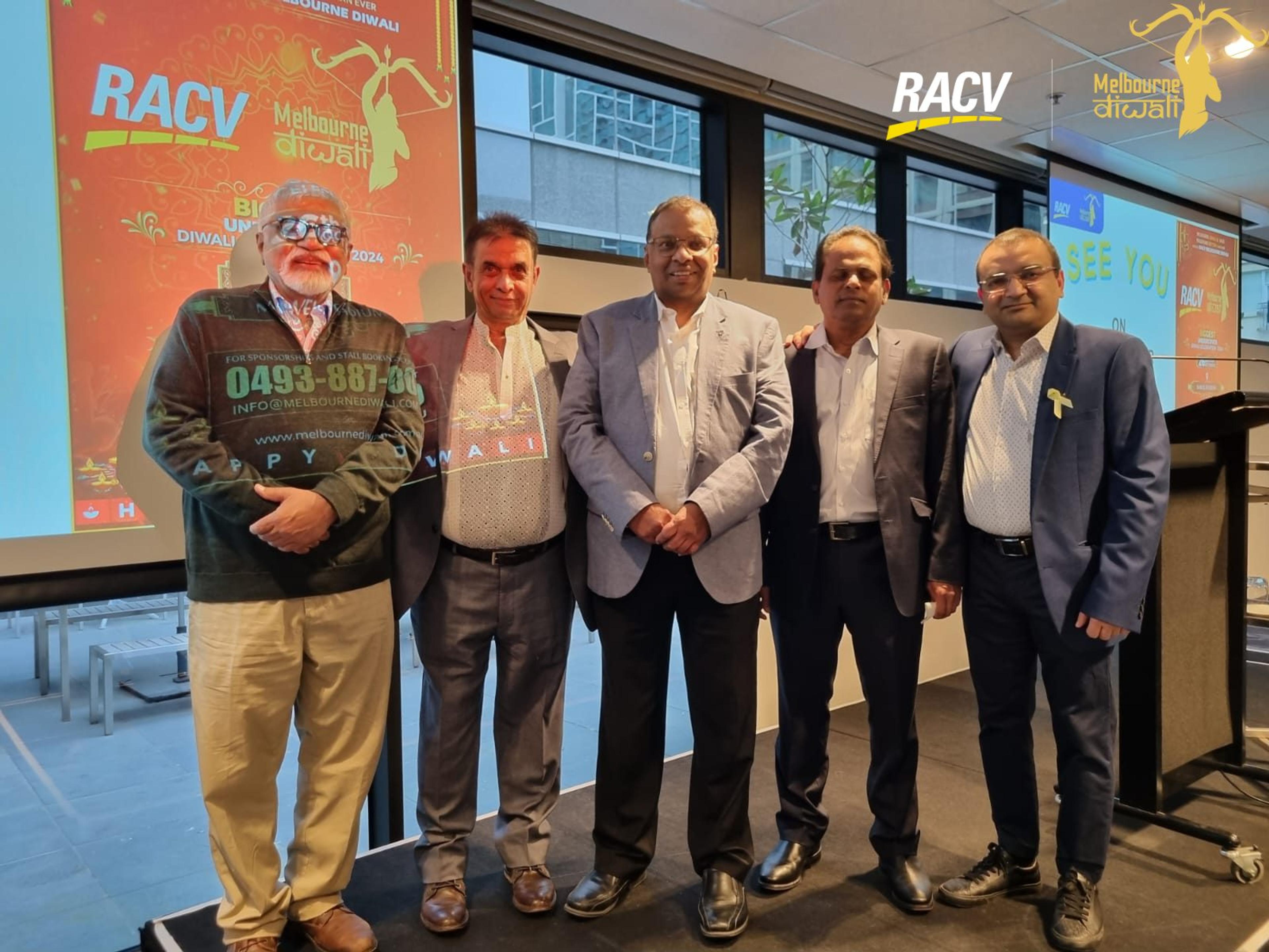 Five guests pose on stage in front of the RACV Melbourne Diwali festival poster