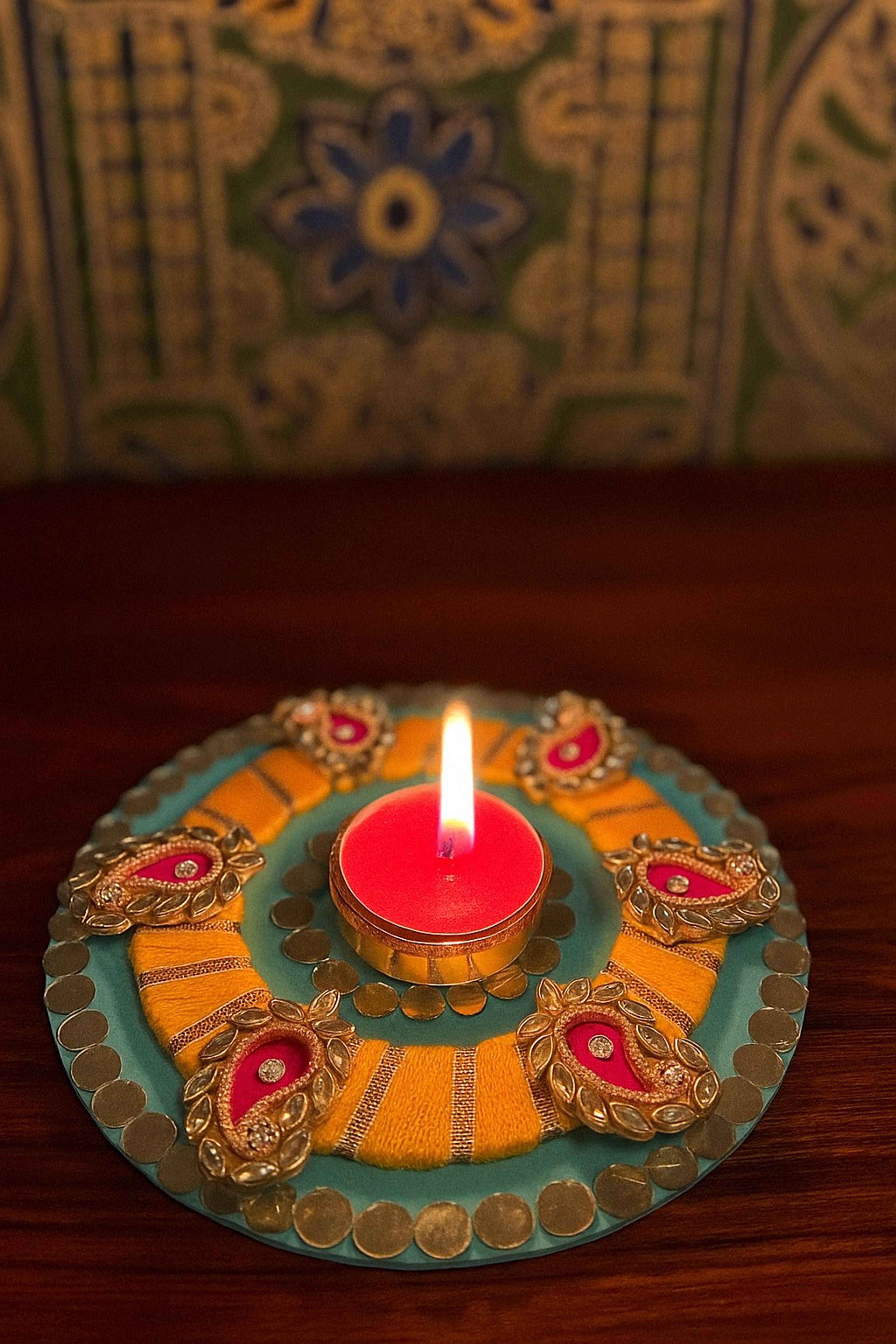 Hand-painted diya with a candle