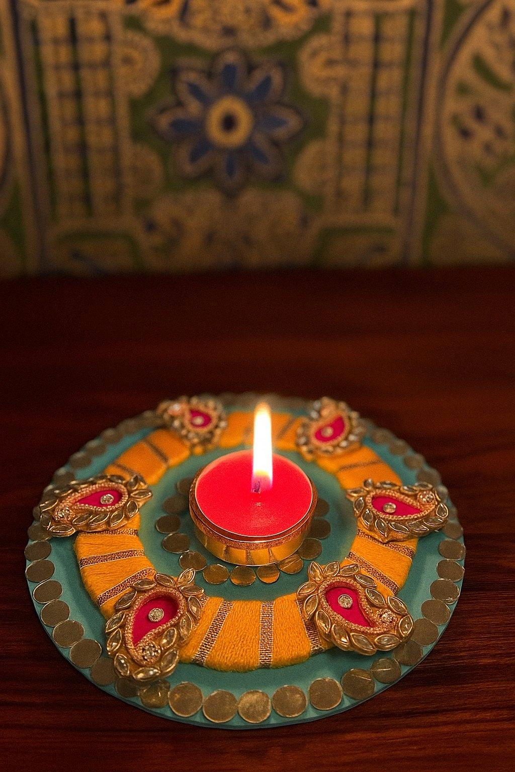 Hand-painted diya with a candle