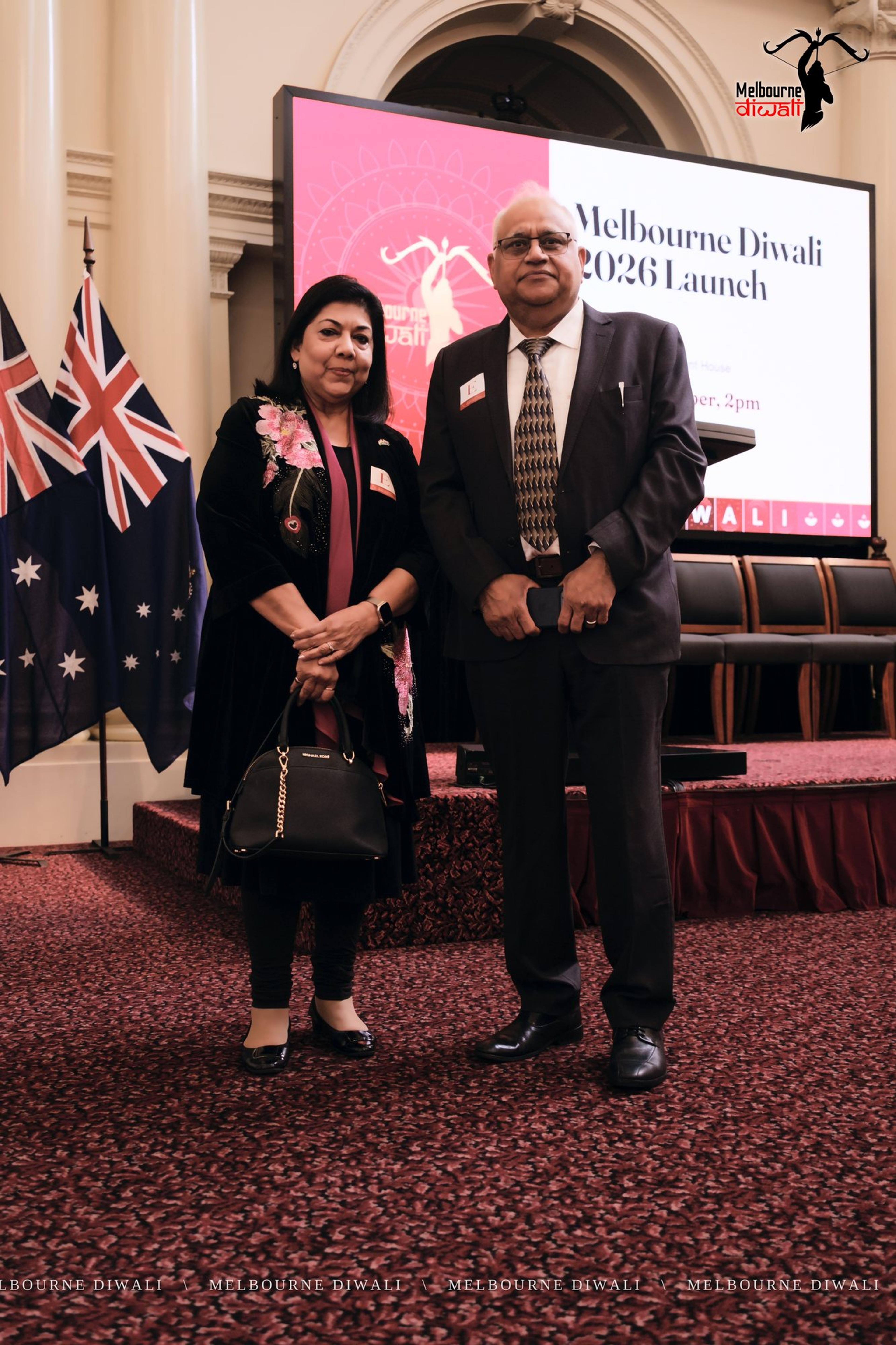 Two guests stand in front of the Launch screen before the programme