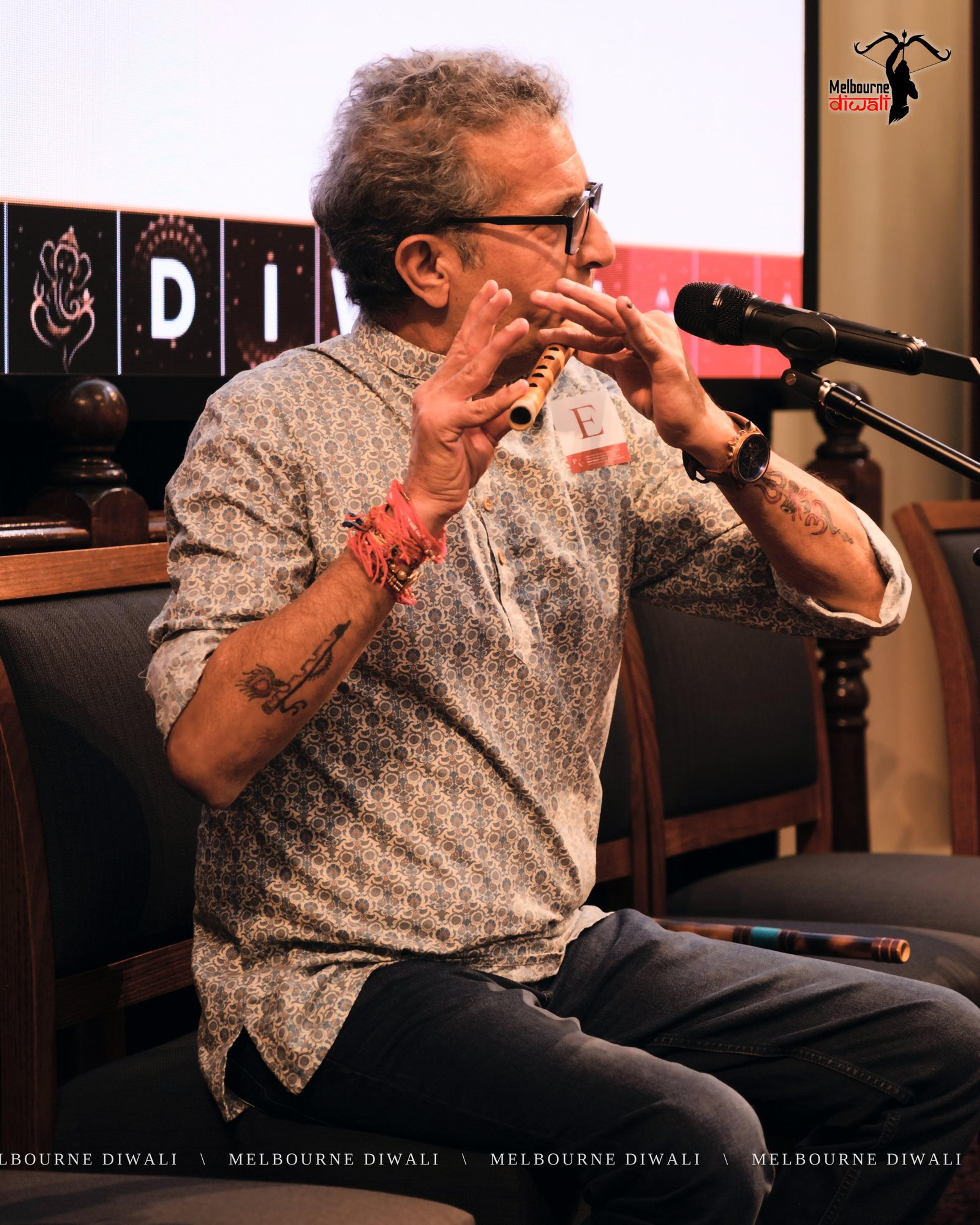 Naresh Sharma plays the flute as the programme closes