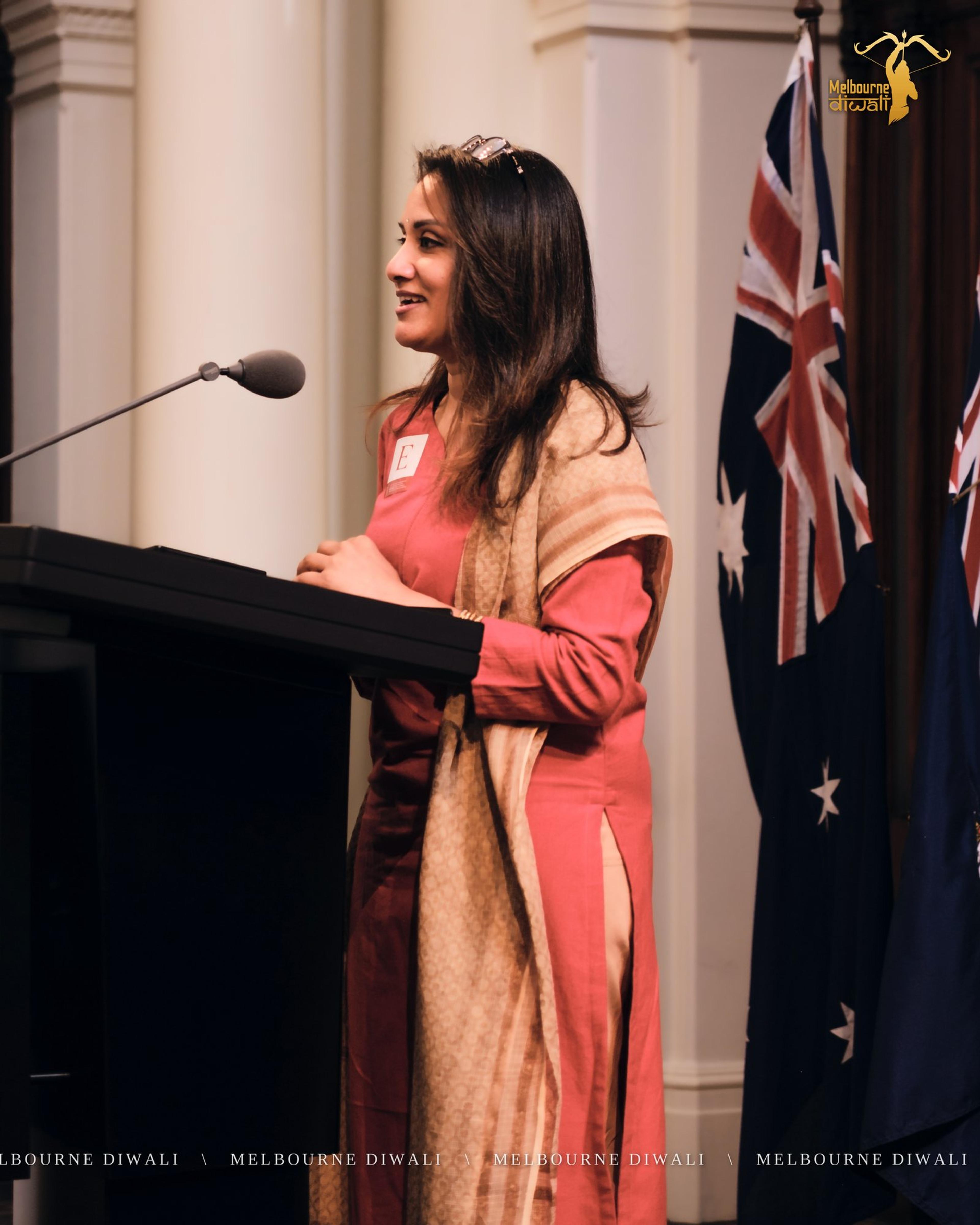 Nithya Remesan, Dance Competition Judge, speaks at the lectern