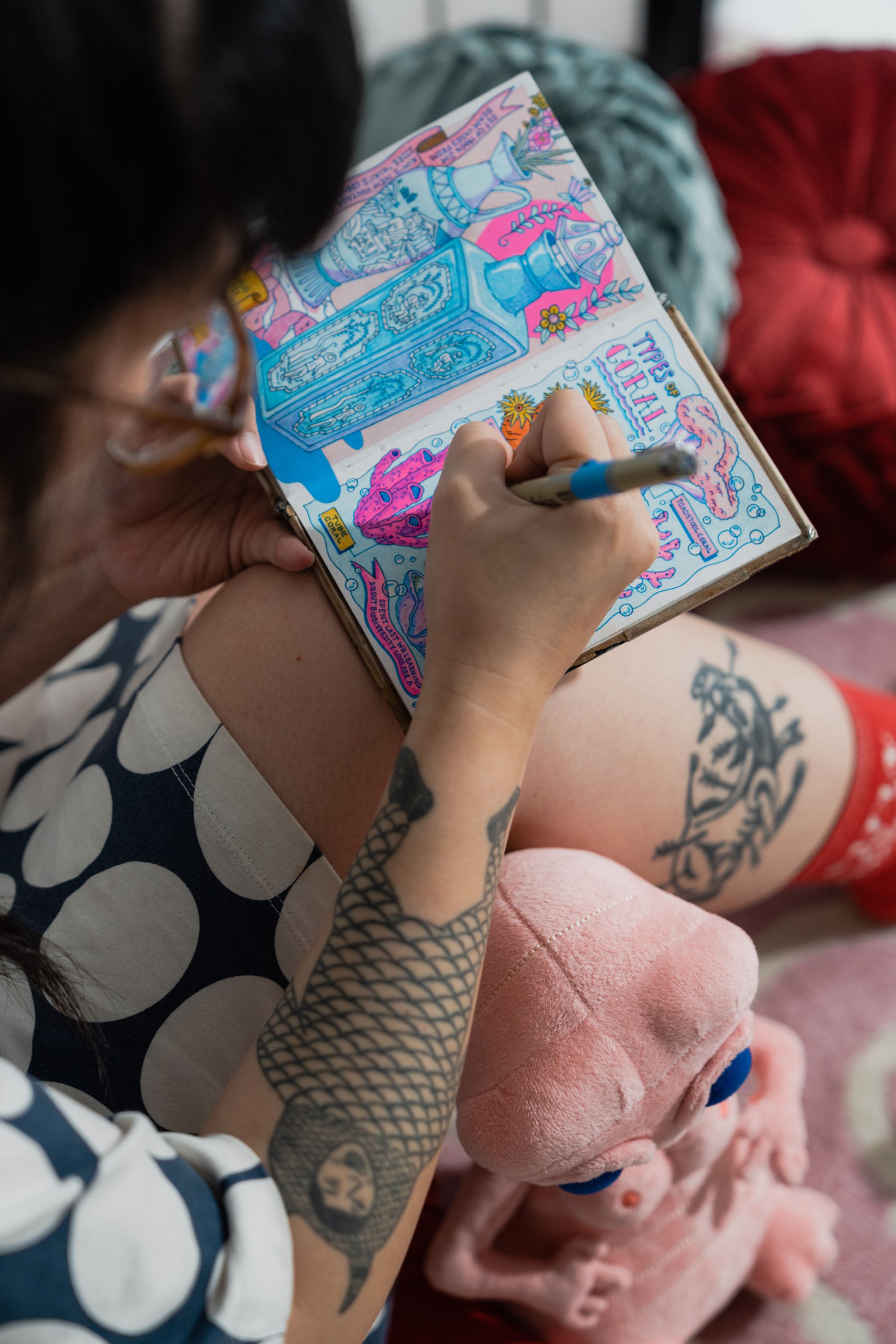 Painter and illustrator Kristen Liu-Wong is photographed sketching in her sketchbook.