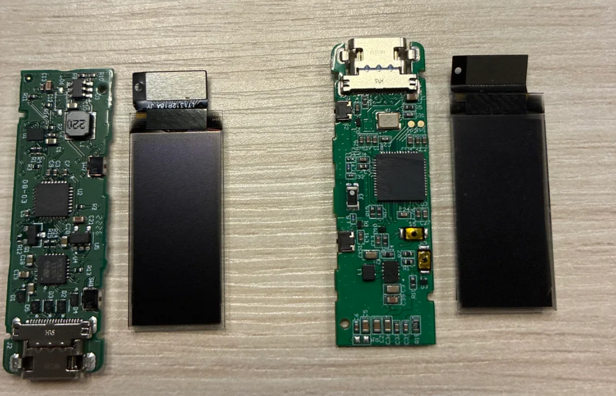 Side-by-side comparison of disassembled Ledger Nano S+ internals. The two components on the left belong to the counterfeit device, showing a green circuit board with a large unidentified chip and a black display panel. The two components on the right belong to the genuine Ledger, showing a more compact circuit board with clearly labeled components and a thinner display panel.