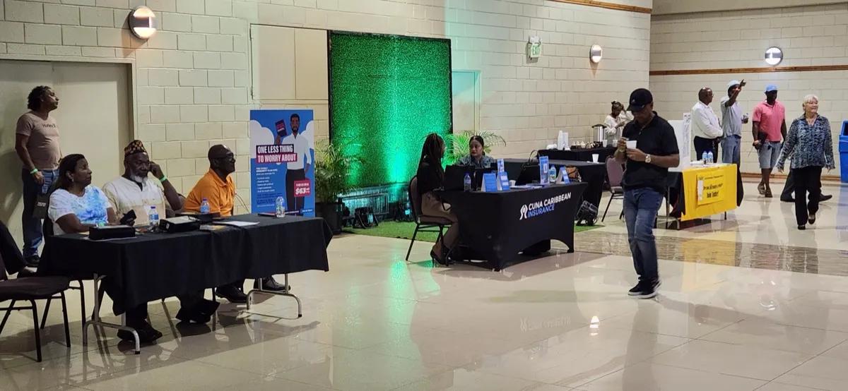 CUNA Caribbean booth and partner tables with members mingling at the 72nd AGM